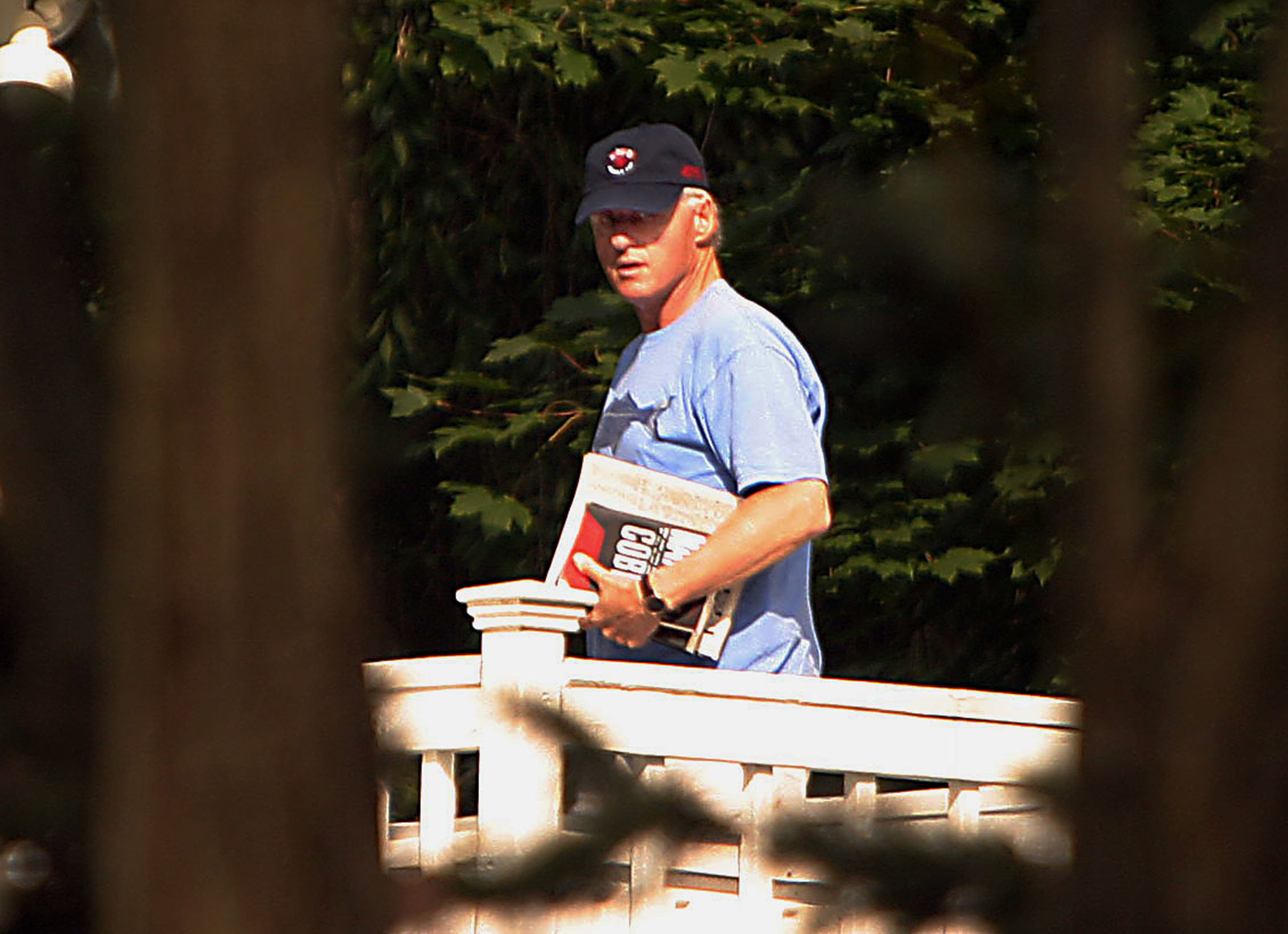 Bill Clinton walks along a patio while recovering from heart surgery at his home in Chappaqua, New York, on September 12, 2004 | Source: Getty Images