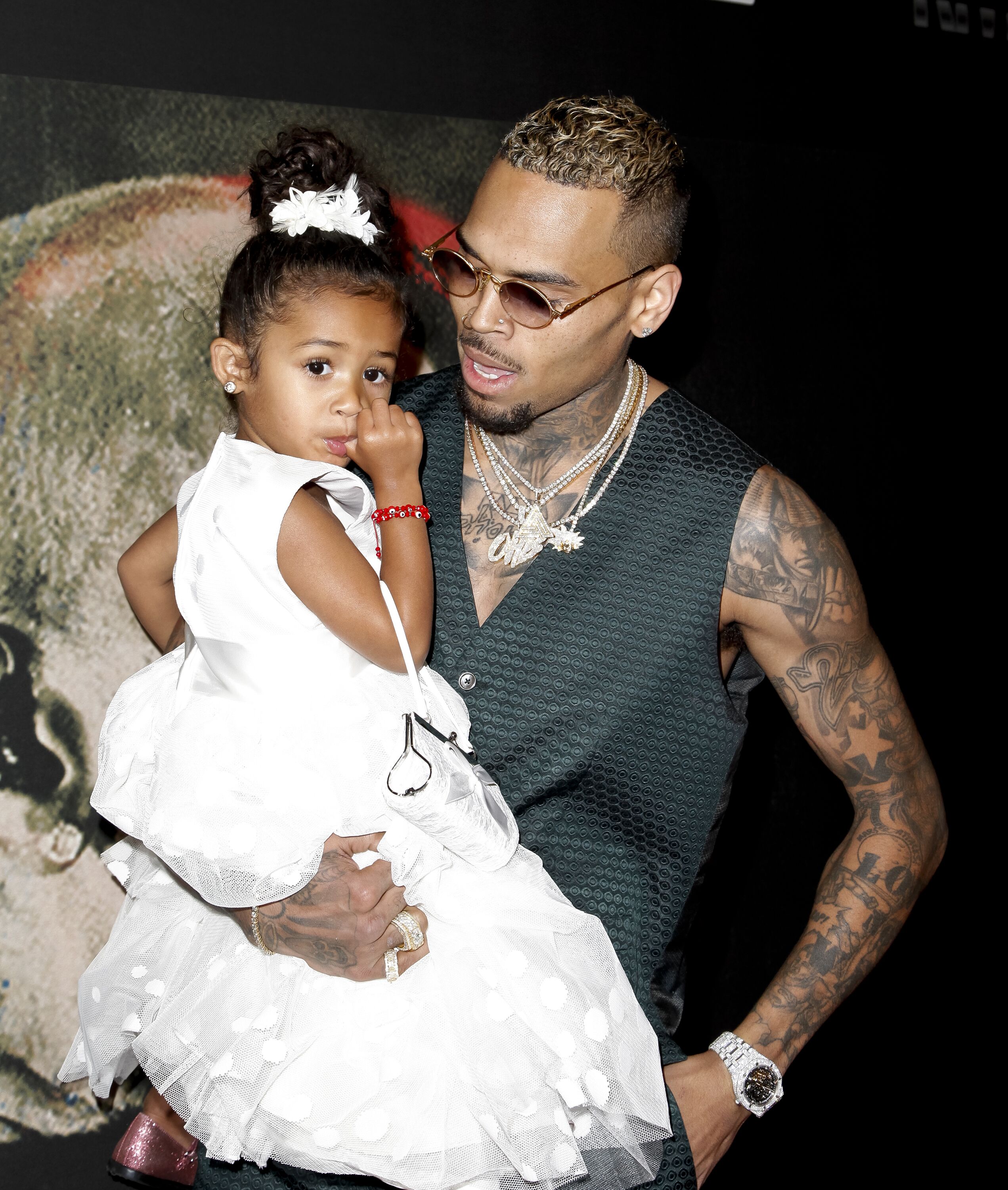 Chris Brown carries his daughter Royalty Brown in his arms as they arrive at the premiere for "Chris Brown: Welcome To My Life" on June 6, 2017, in Los Angeles, California | Source:  Jonathan Leibson/Getty Images