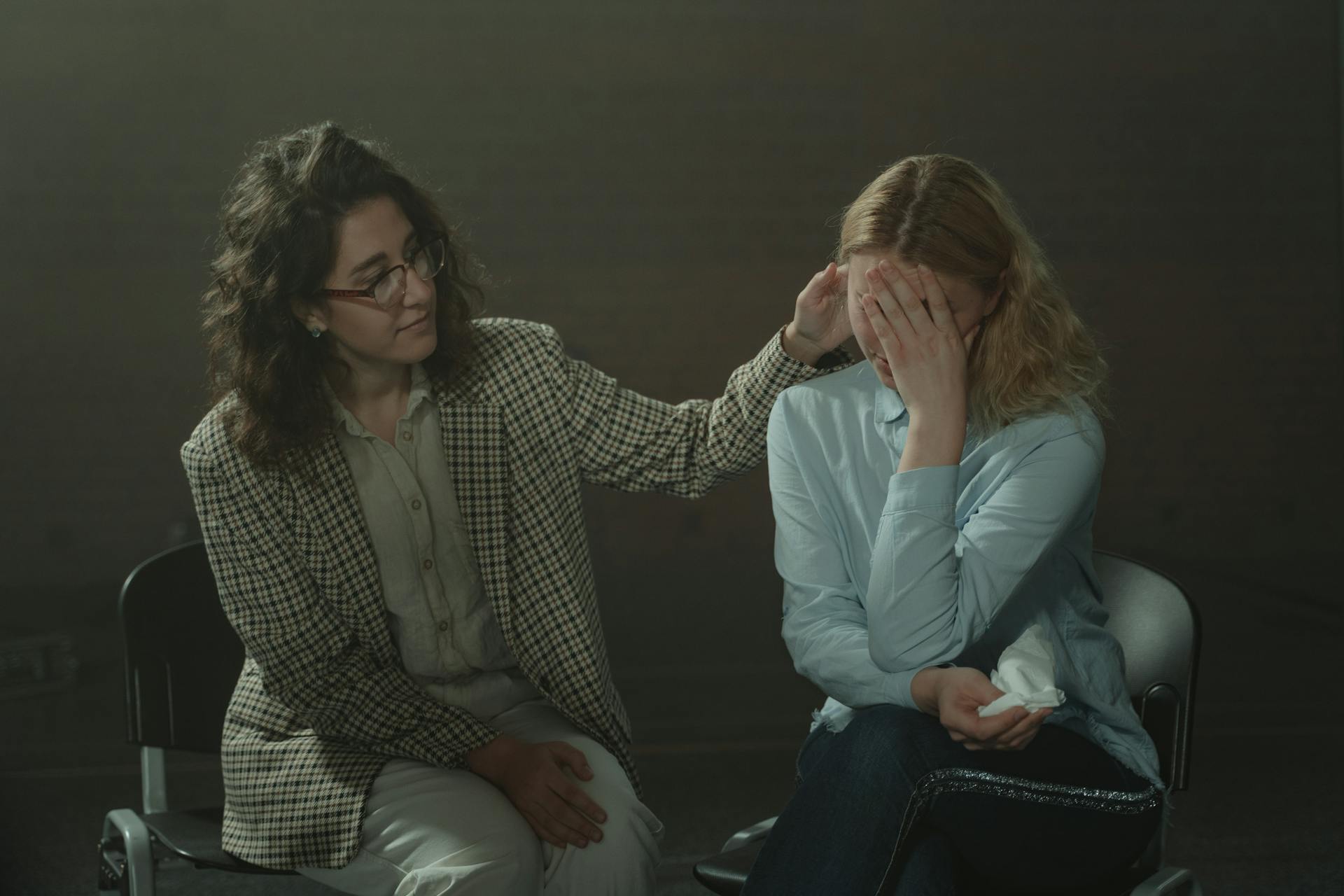 A woman comforts another distressed lady during a support group discussion | Source: Pexels