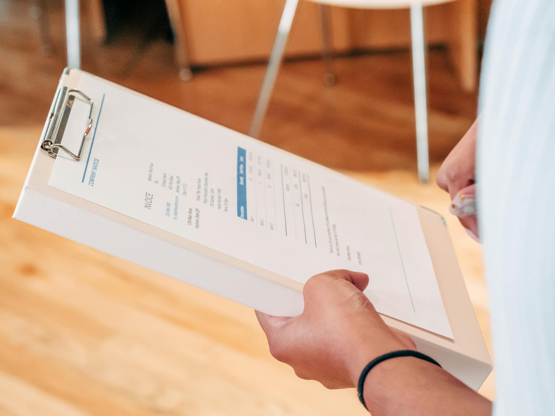 A woman holding an invoice | Source: Pexels