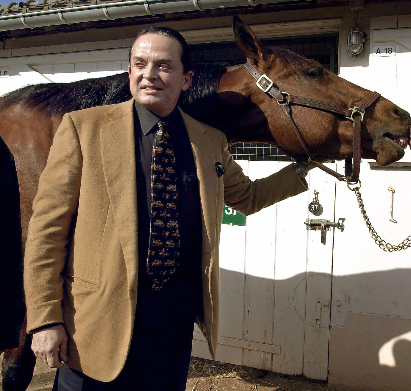 Alec Wildenstein  posing with his horse Kesaco Phedo, winner of the three-year Criterium and of the Prix de Vincennes, on March 7, 2002. | Source: Getty Images