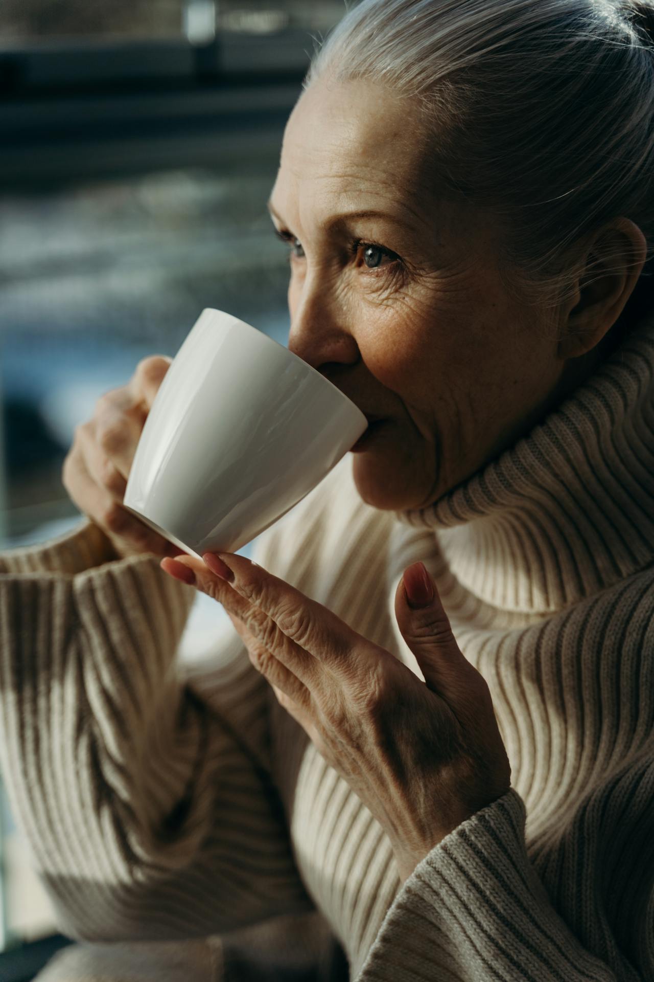 An older woman drinking a cup of beverage | Source: Pexels
