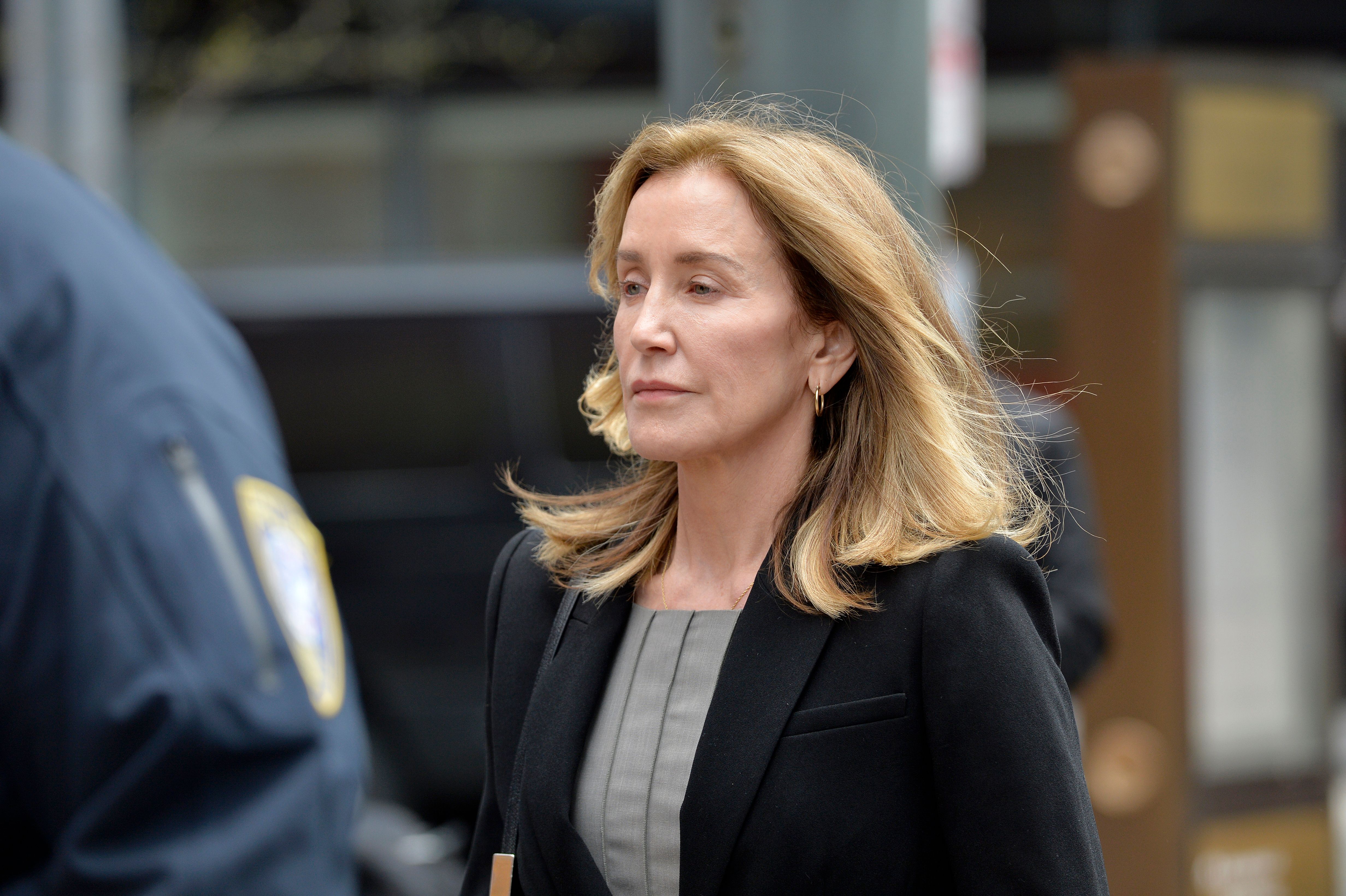 Felicity Huffman is escorted by Police into court on May 13, 2019 in Boston, Massachusetts. | Source: Getty Images