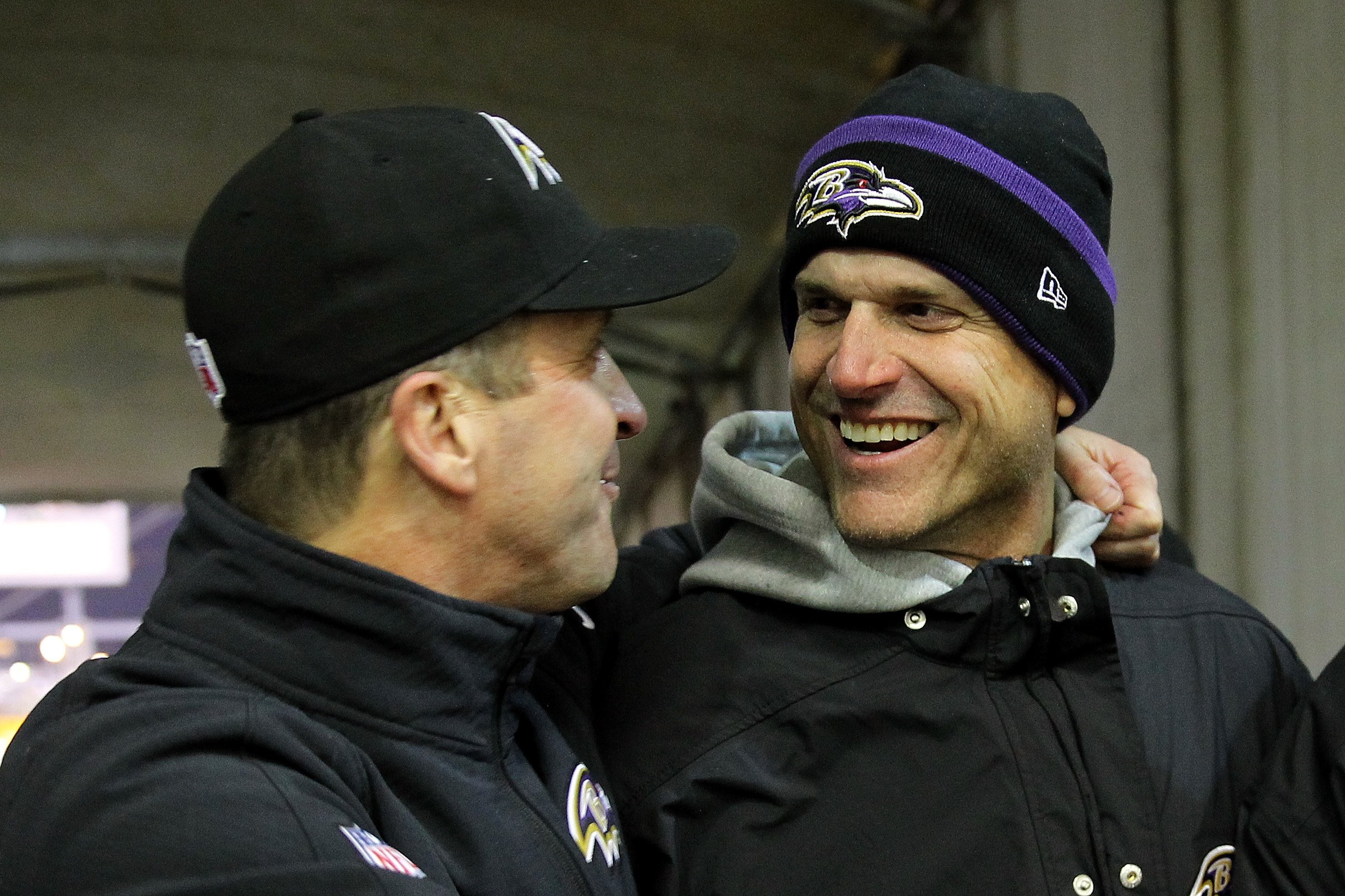 Michigan coach Jim Harbaugh (R) celebrates with his brother, head coach John Harbaugh (L) of the Baltimore Ravens after the Ravens defeated the Pittsburgh Steelers 30-17 in their AFC Wild Card game at Heinz Field, on January 3, 2015, in Pittsburgh, Pennsylvania. | Source: Getty Images