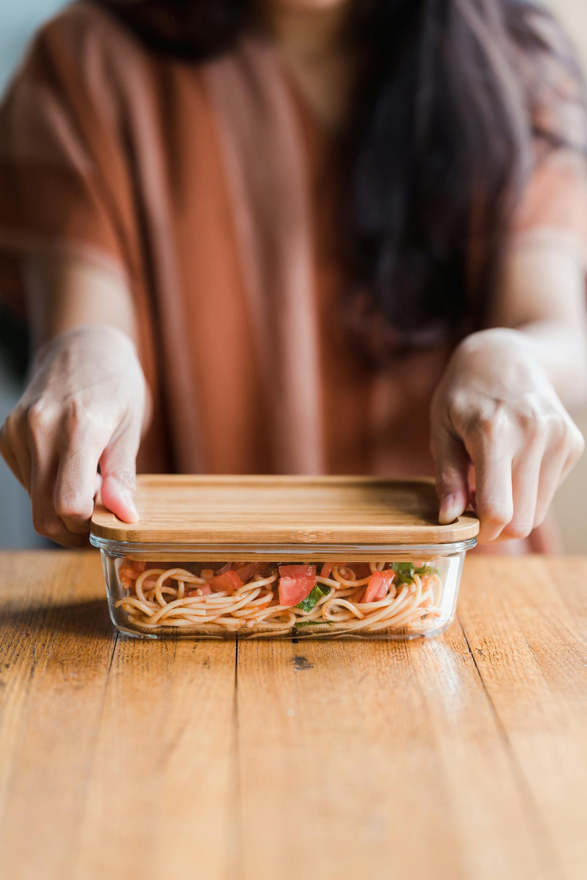 Close-up of a person holding a food container | Source: Pexels