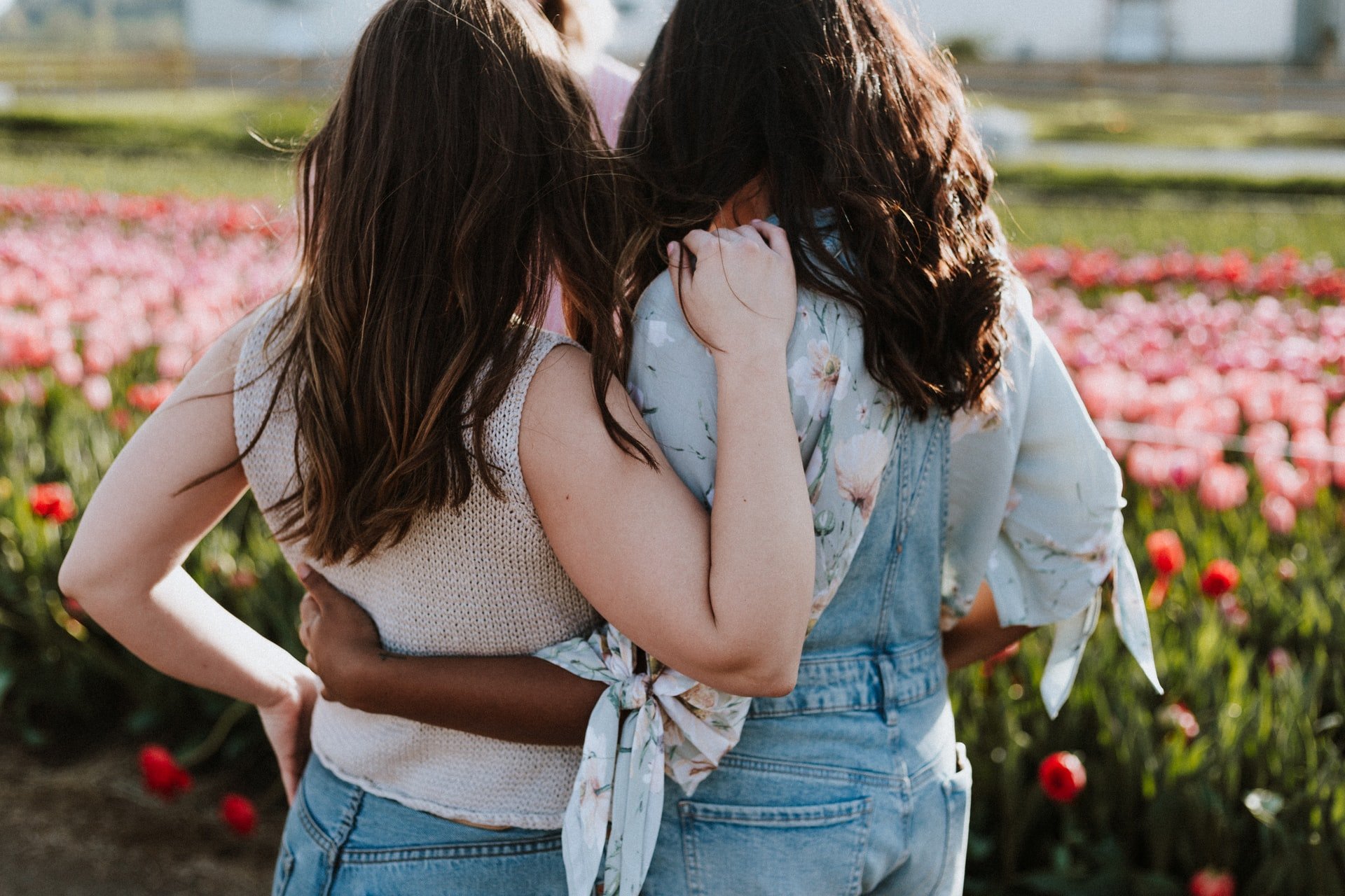 Two girls standing in front of flower field | Source: Unsplash