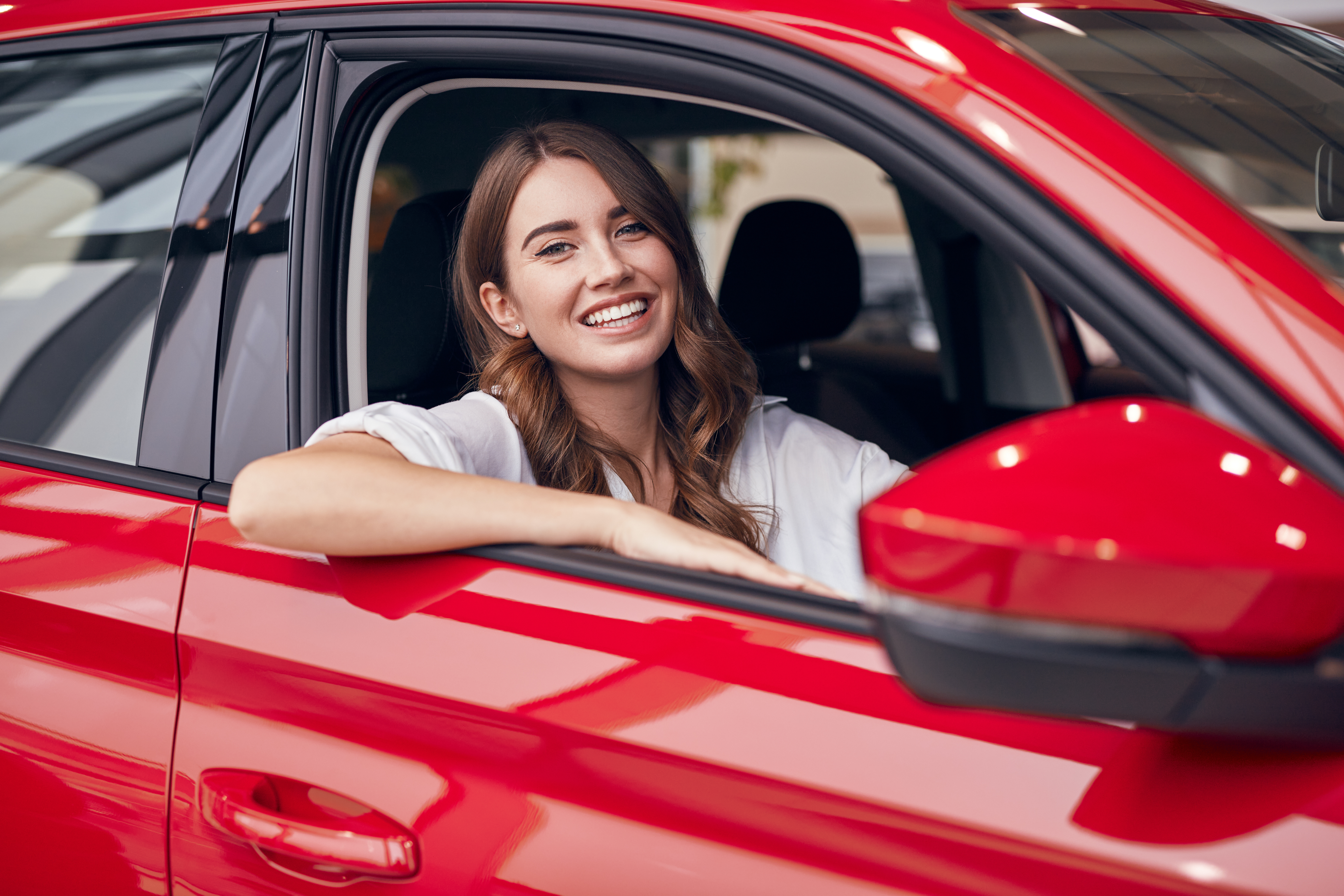 A woman smiling in a car | Source: Shutterstock