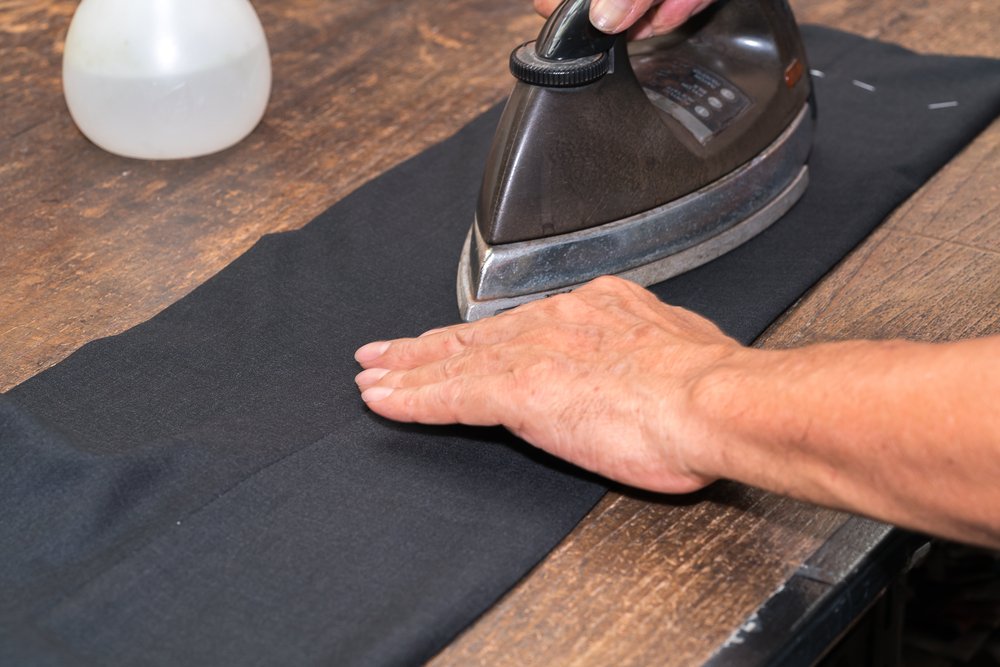 A man ironing pants. | Photo: Shutterstock