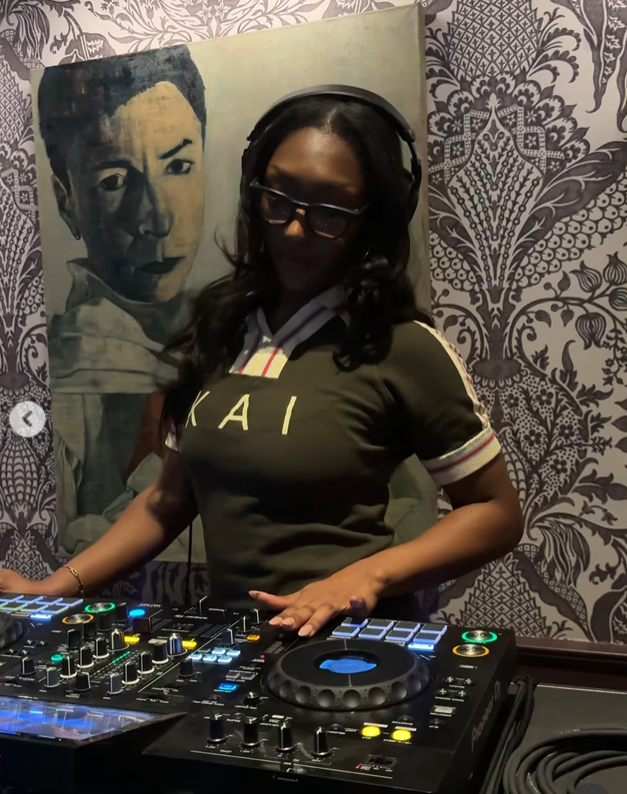 Isan Elba strikes a confident pose behind a DJ console, wearing oversized glasses and headphones. | Source: Instagram/isanelba