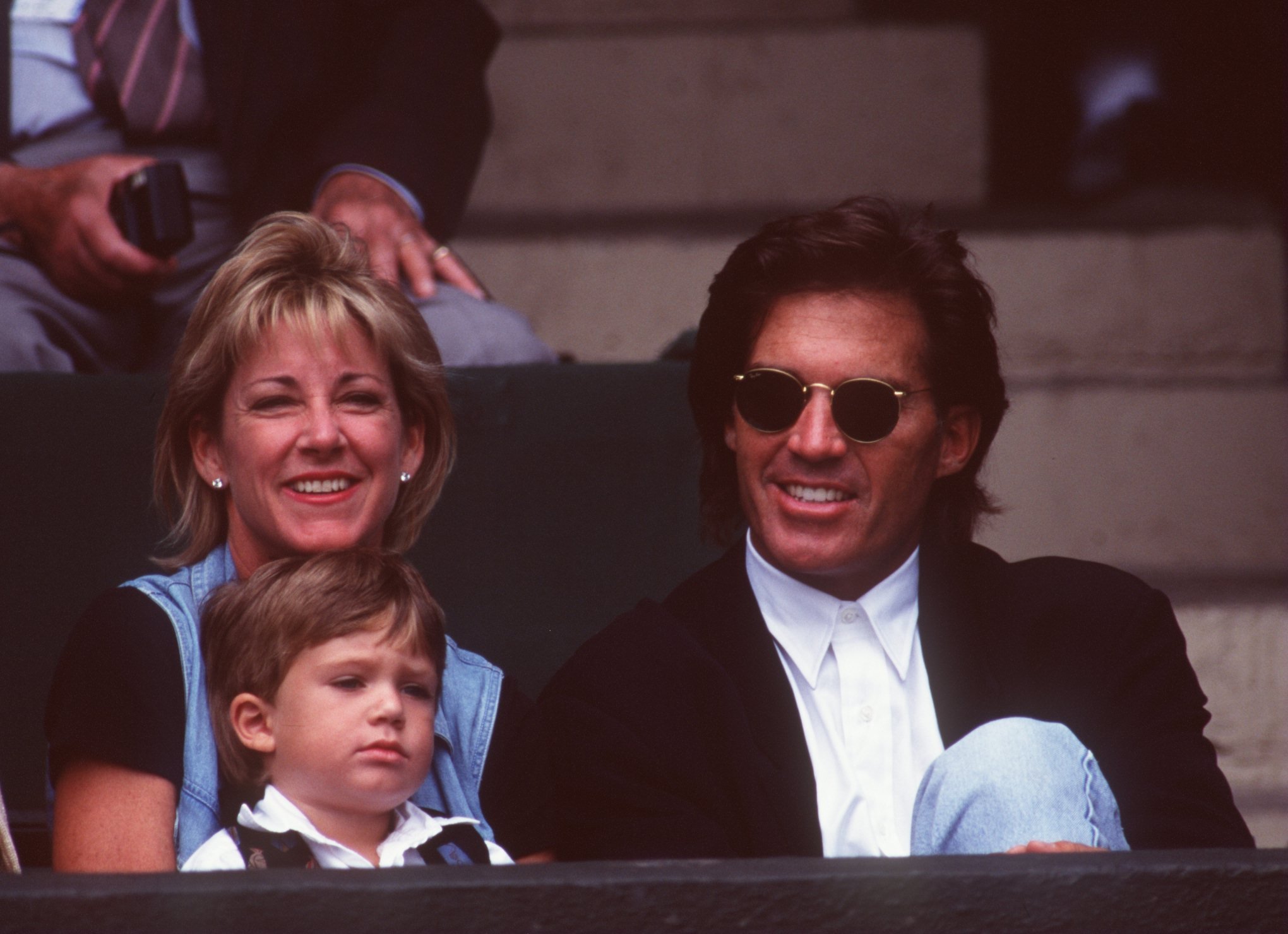 Chris Evert during the men's quarter finals at Wimbledon with Andy Mills and young son on 5 Jul 1995. | Source: Getty Images