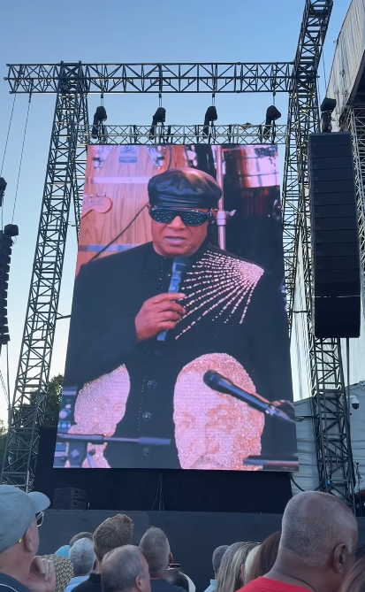 Stevie Wonder seen on a concert screen talking about the rumors about his eyesight during his tour stop at Cardiff, Wales on July 10, 2025 | Source: Instagram/cardifflife.wales