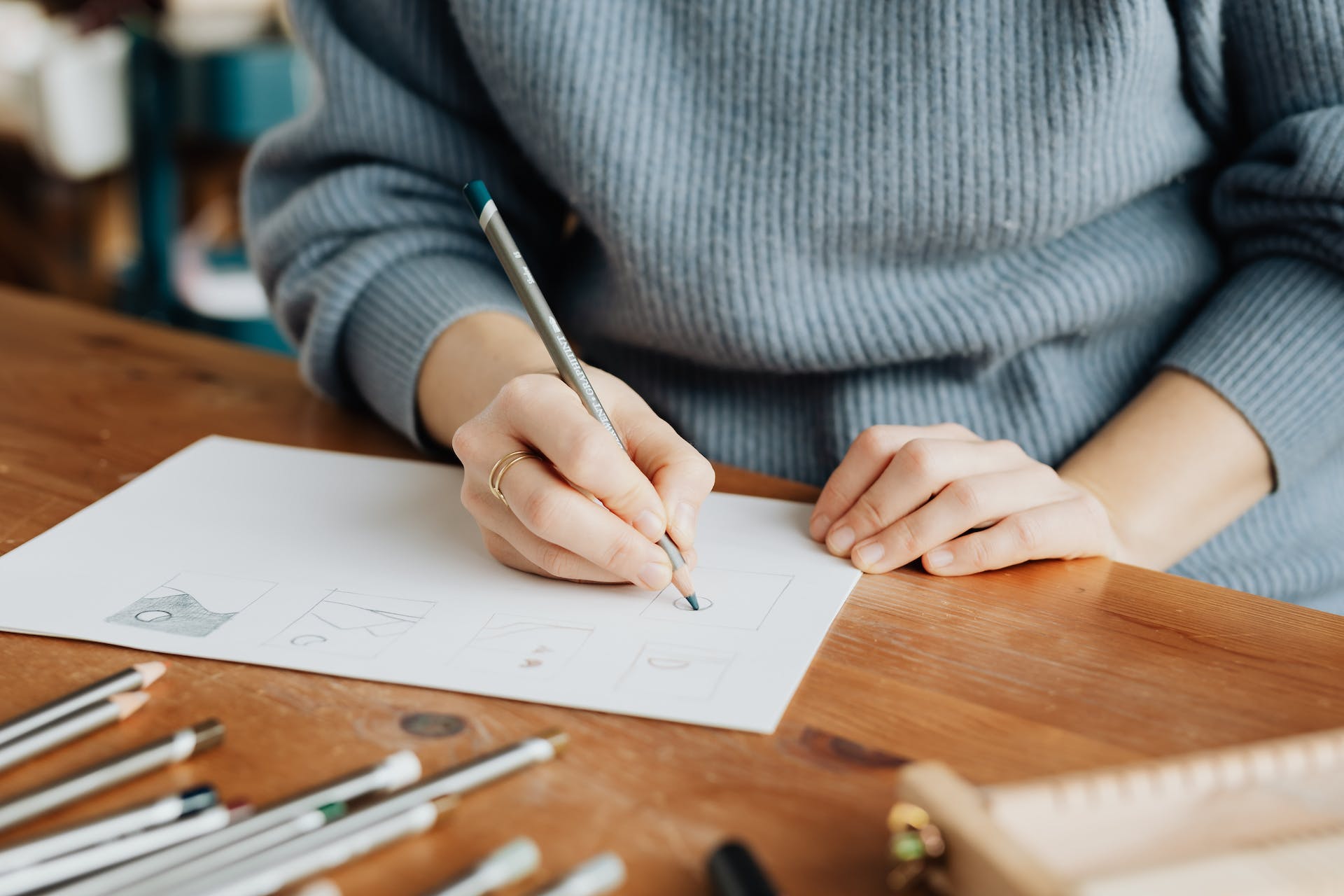 Person sketching on paper | Source: Pexels