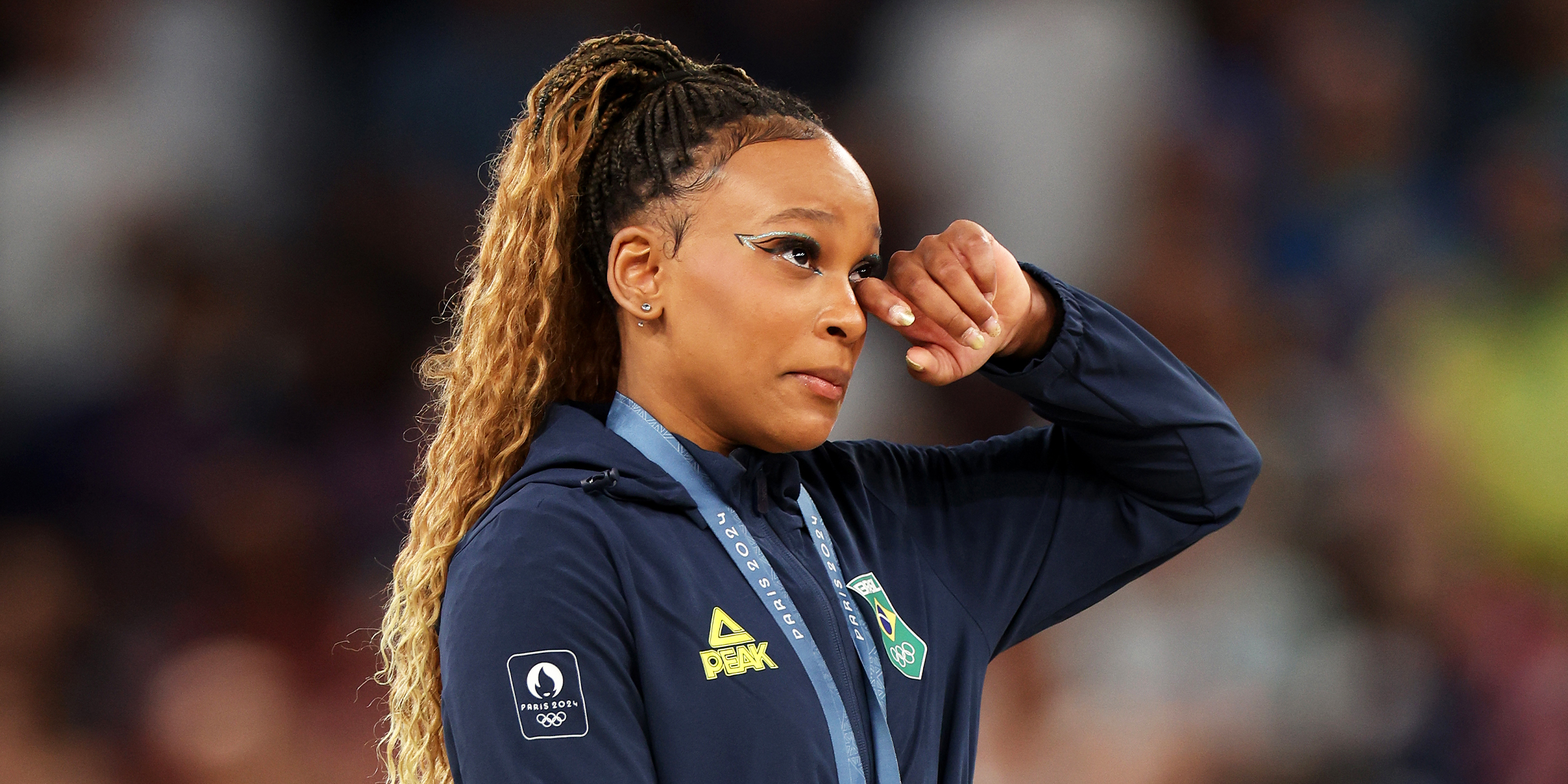 Rebeca Andrade of Team Brazil shows emotion on the podium at the Artistic Gymnastics Women's Floor Exercise Medal Ceremony on day ten of the Olympic Games Paris 2024 at Bercy Arena on August 05, 2024 in Paris, France | Source: Getty Images