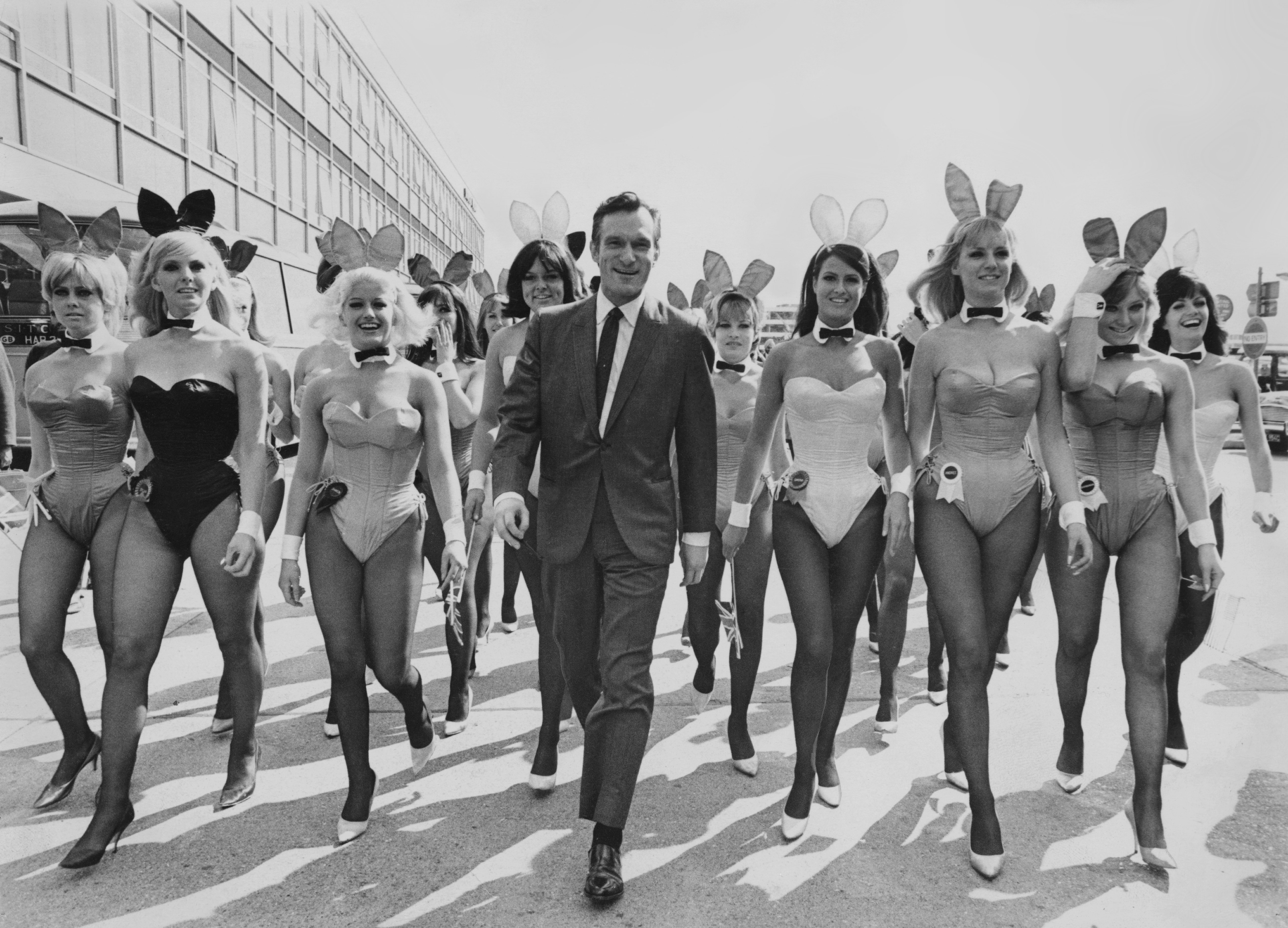 Hugh Hefner arrives at London Airport from Chicago with an entourage of Playboy Bunnies, in 1966, for the opening of the London Playboy Club on Park Lane | Source: Getty Images