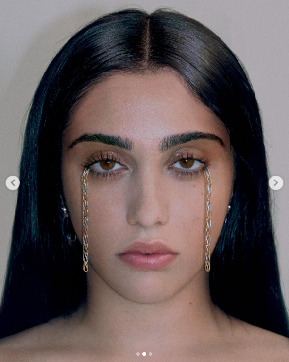 Lourdes Leon poses with a serious look as the corners of her lower lash line are attached with chains, July 2023. | Source: Instagram/lourdesleon