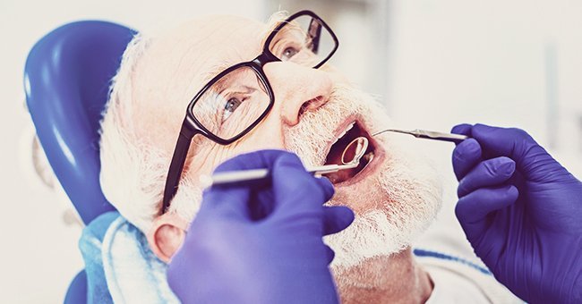 A pastor getting his teeth fixed by the dentist | Photo: Shutterstock