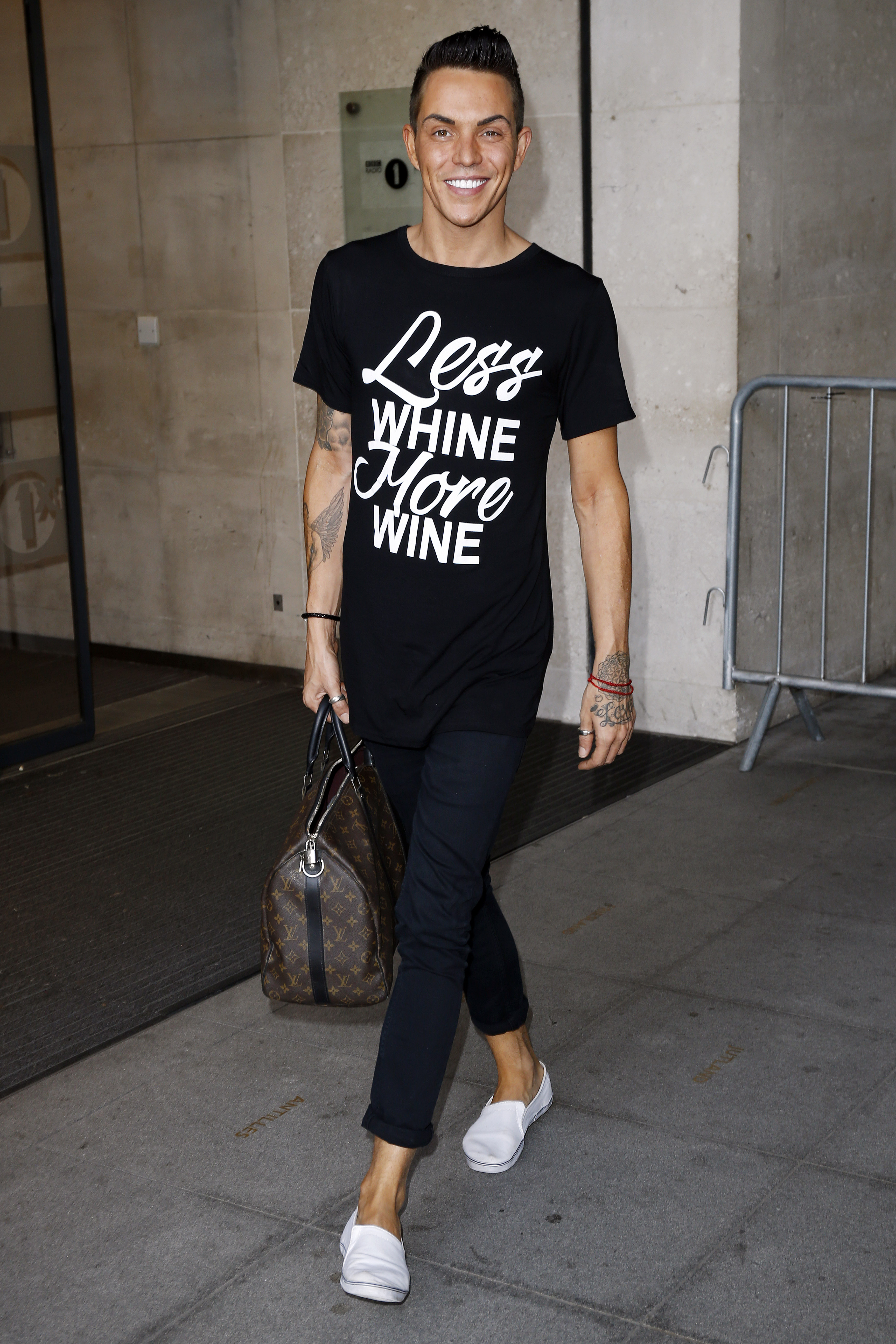 Looking relaxed and unhurried outside BBC Radio 1's London studios in October 2014, Norris strolled out in a slogan tee, dark skinnies, and white slip-ons, a Louis Vuitton holdall swinging at his side.