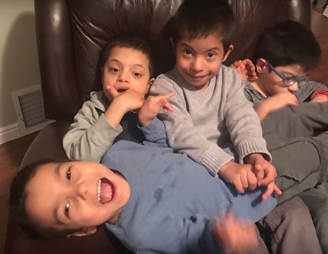 Simon and his three adoptive brothers l Source: Youtube/Carters Clips