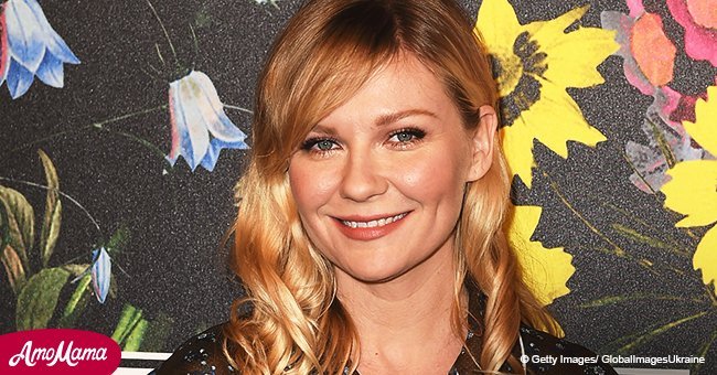 Heavily pregnant Kirsten Dunst shows off her burgeoning baby bump in a form-fitting dress