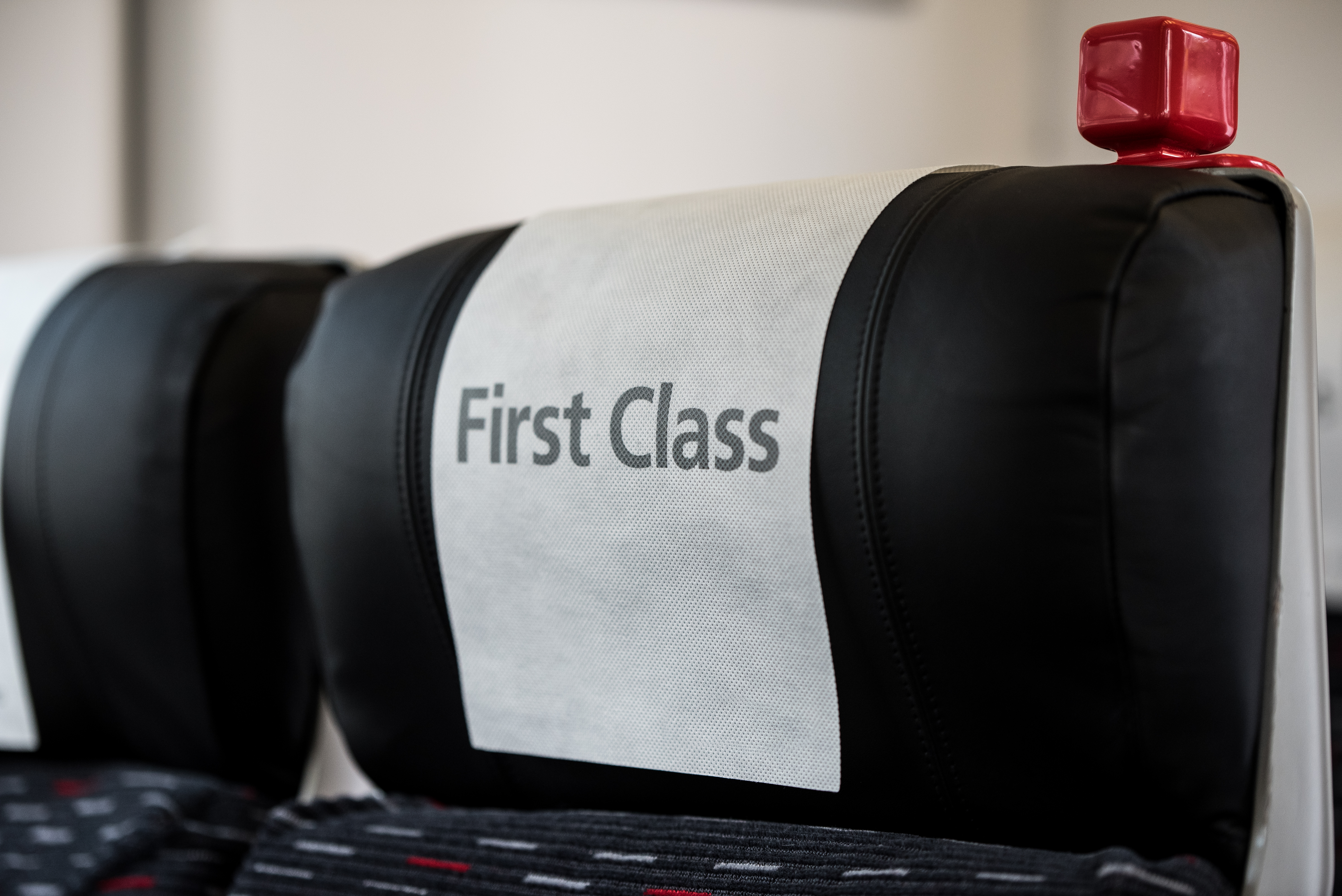 A train seat with a sign that reads "First Class" | Source: Shutterstock