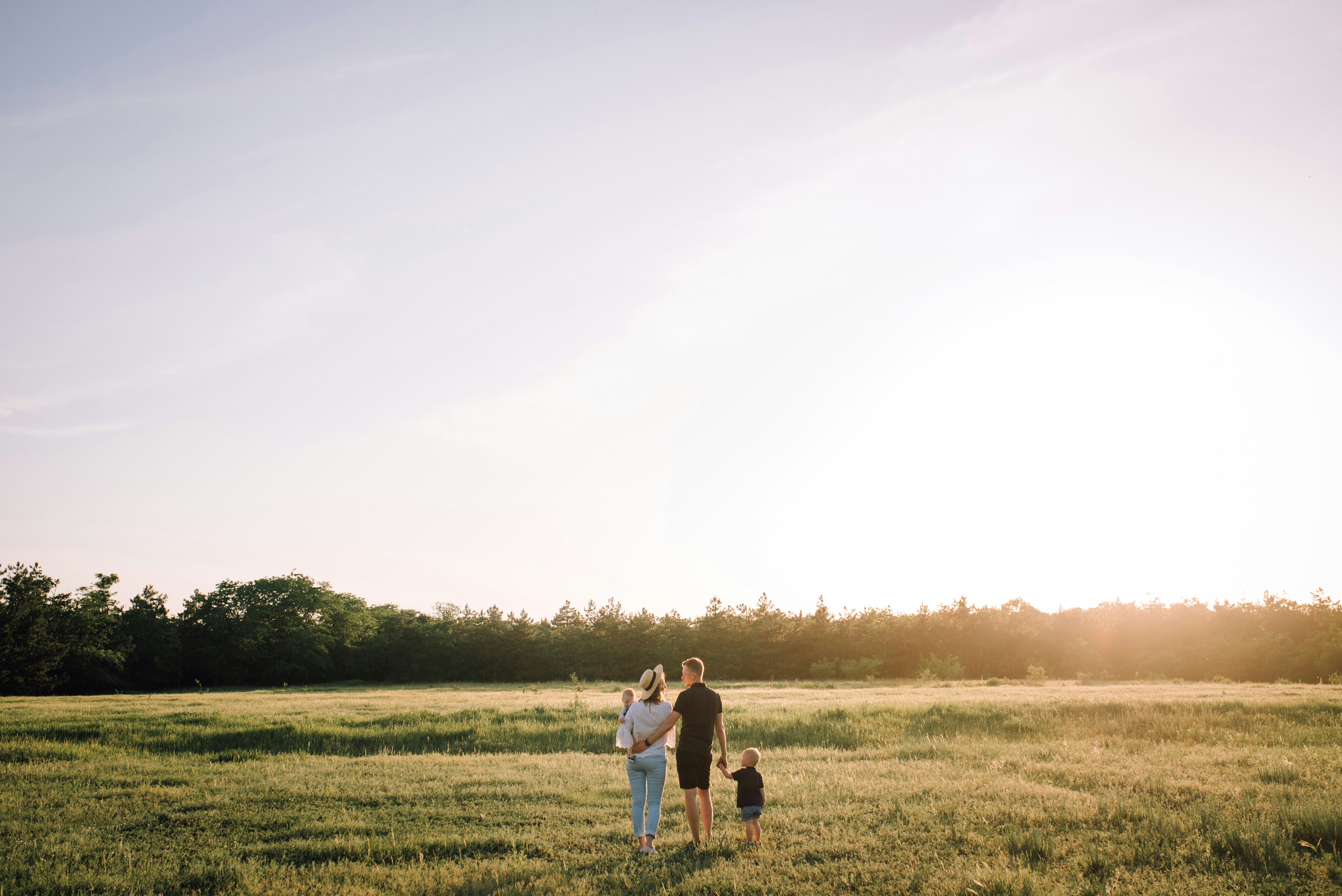 Happy family in a field | Source: Pexels