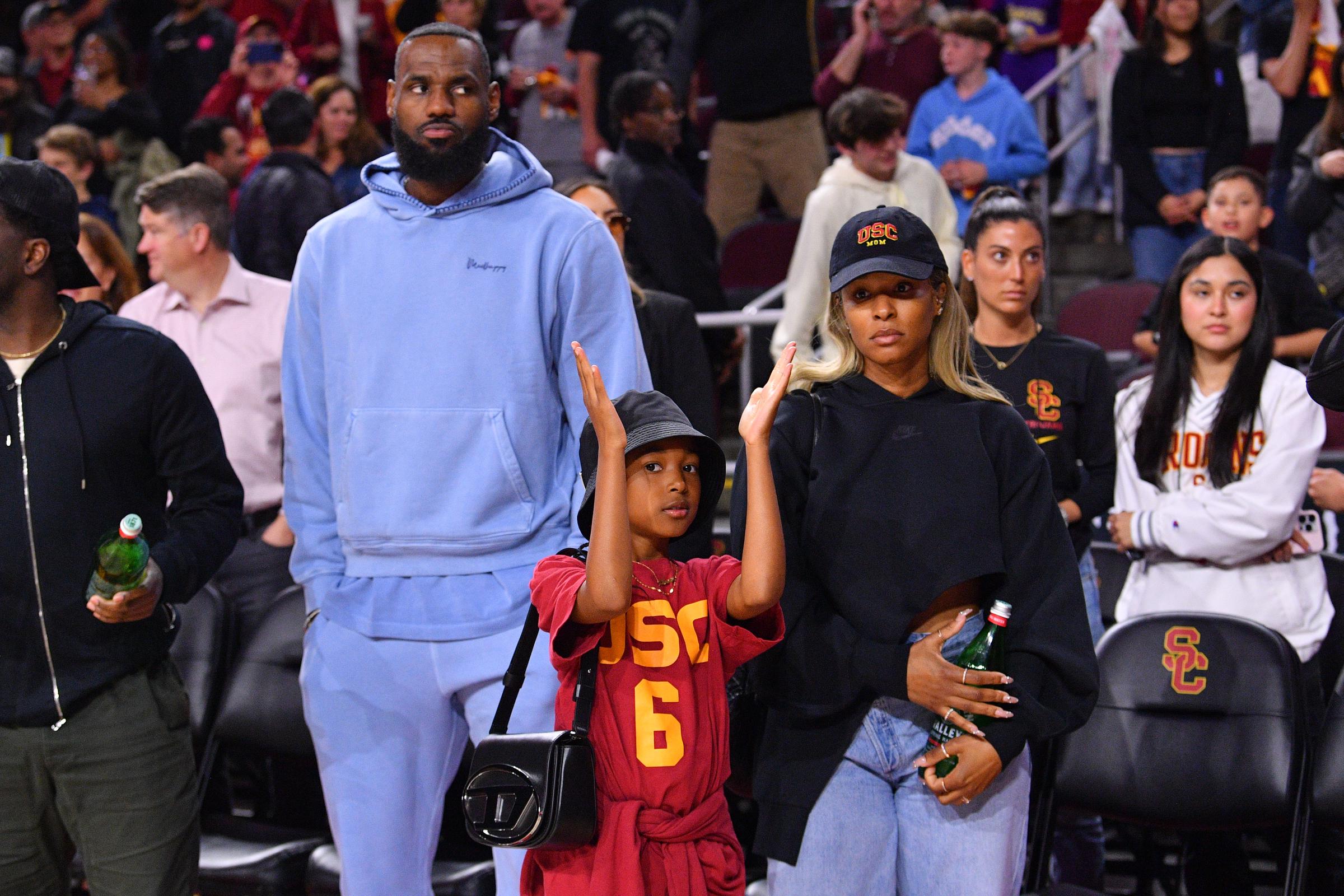 LeBron, Zhuri, and Savannah James at a college basketball game between the Arizona Wildcats and the USC Trojans in Los Angeles, California on March 9, 2024 | Source: Getty Images