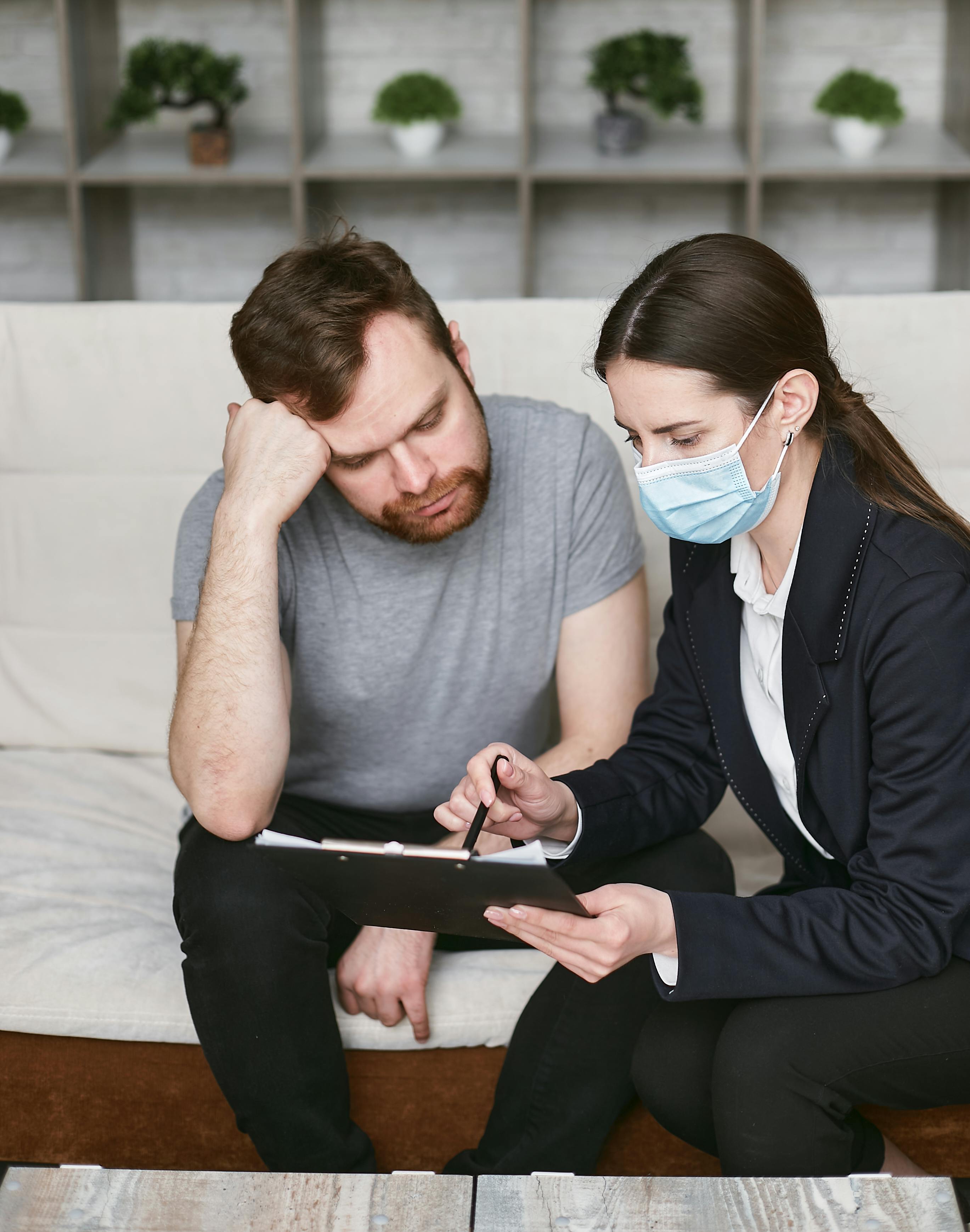 A man and a woman reading a document | Source: Pexels