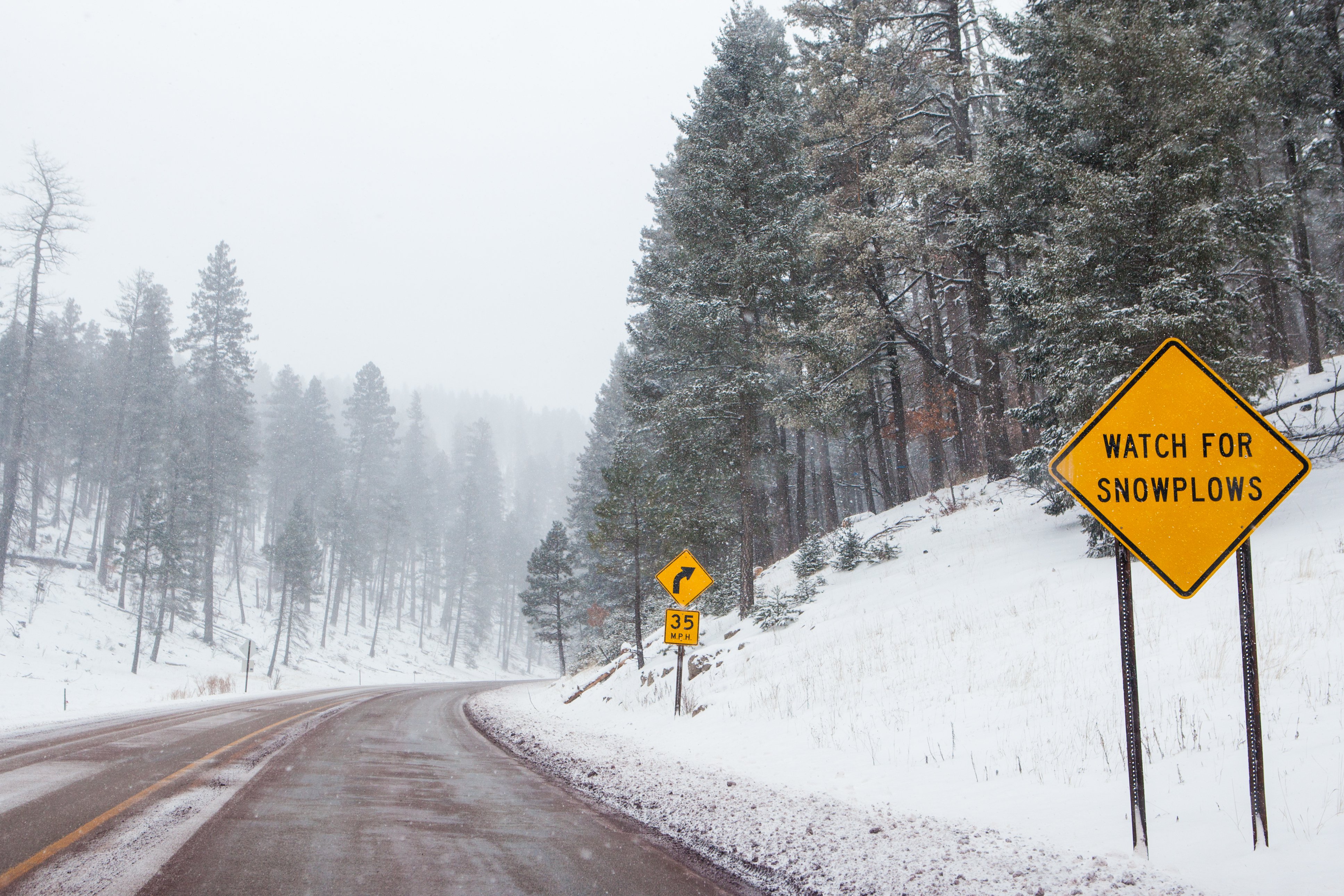 Pictured - A snowy mountain road with warning signs in Cloudcroft, New Mexico | Photo: Shutterstock