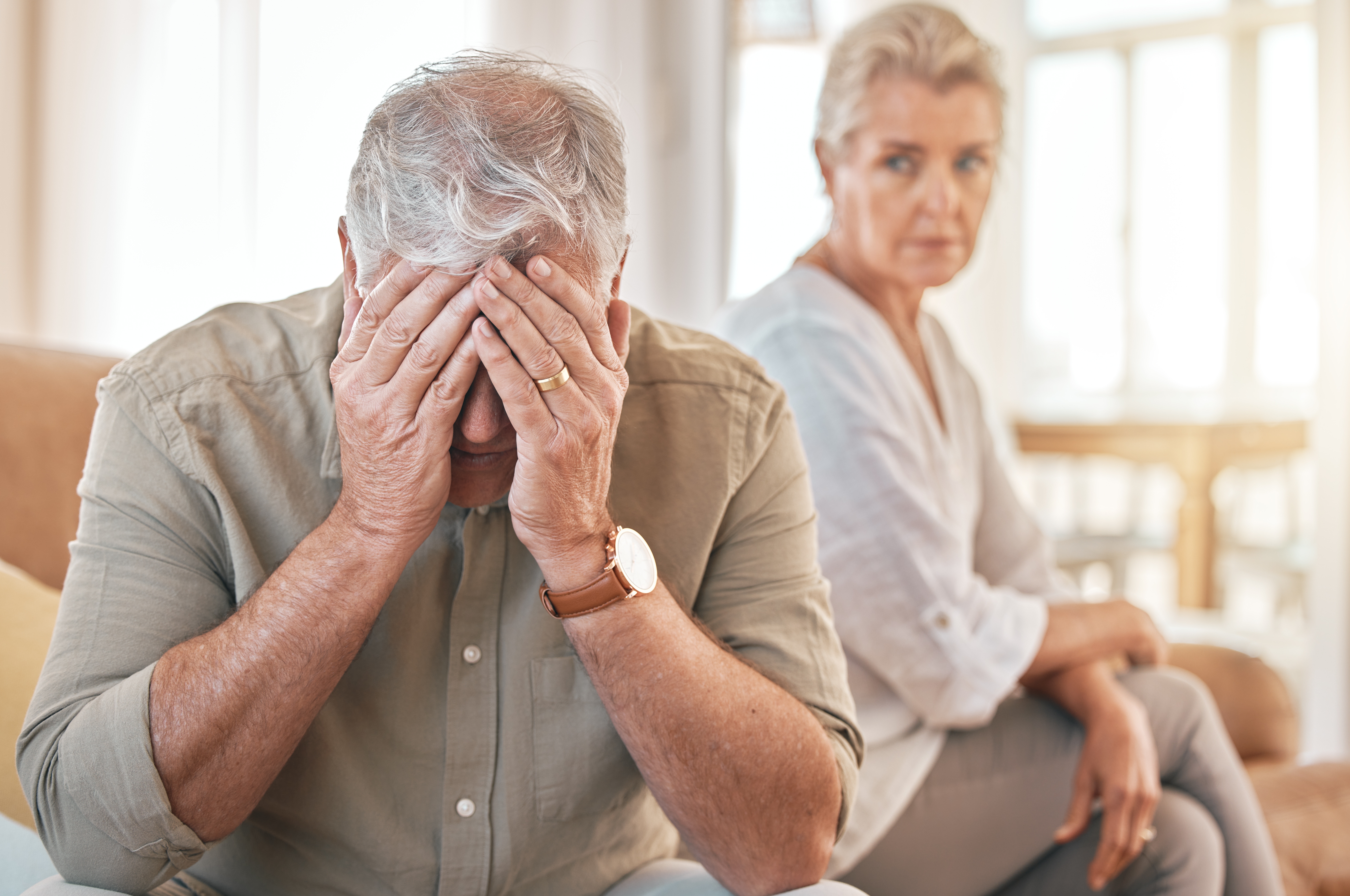 Senior couple sitting apart after a major conflict | Source: Shutterstock