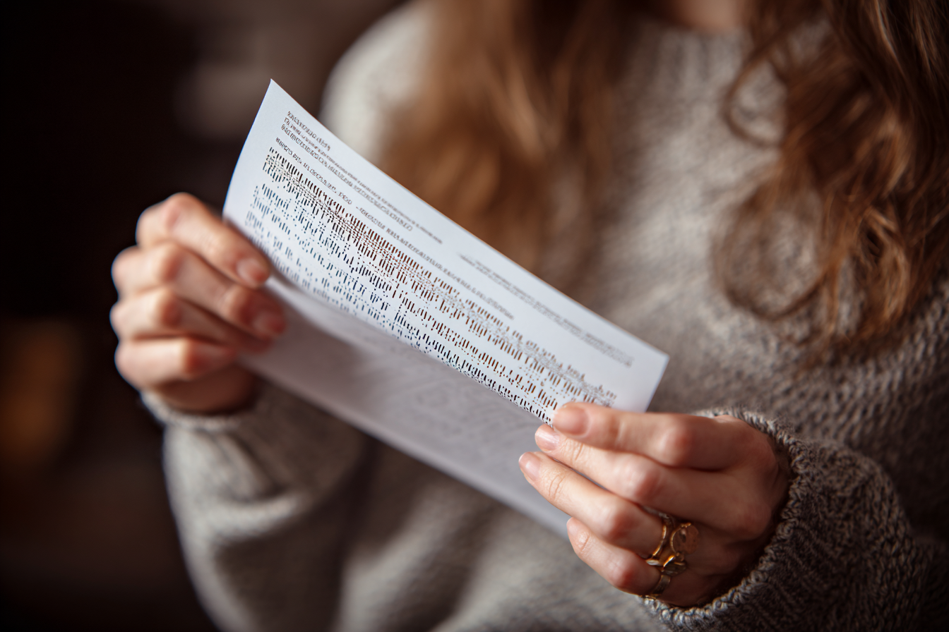 A woman holding a DNA test report | Source: Midjourney