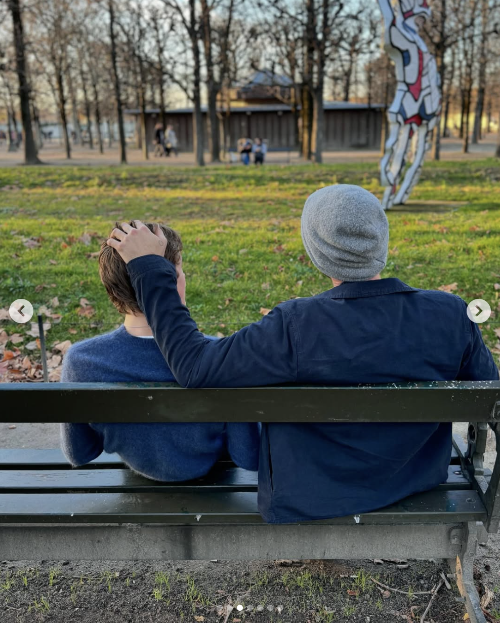 Chris and Moses Martin are captured sitting on a bench in a photo shared on December 1, 2024 | Source: Instagram/gwynethpaltrow