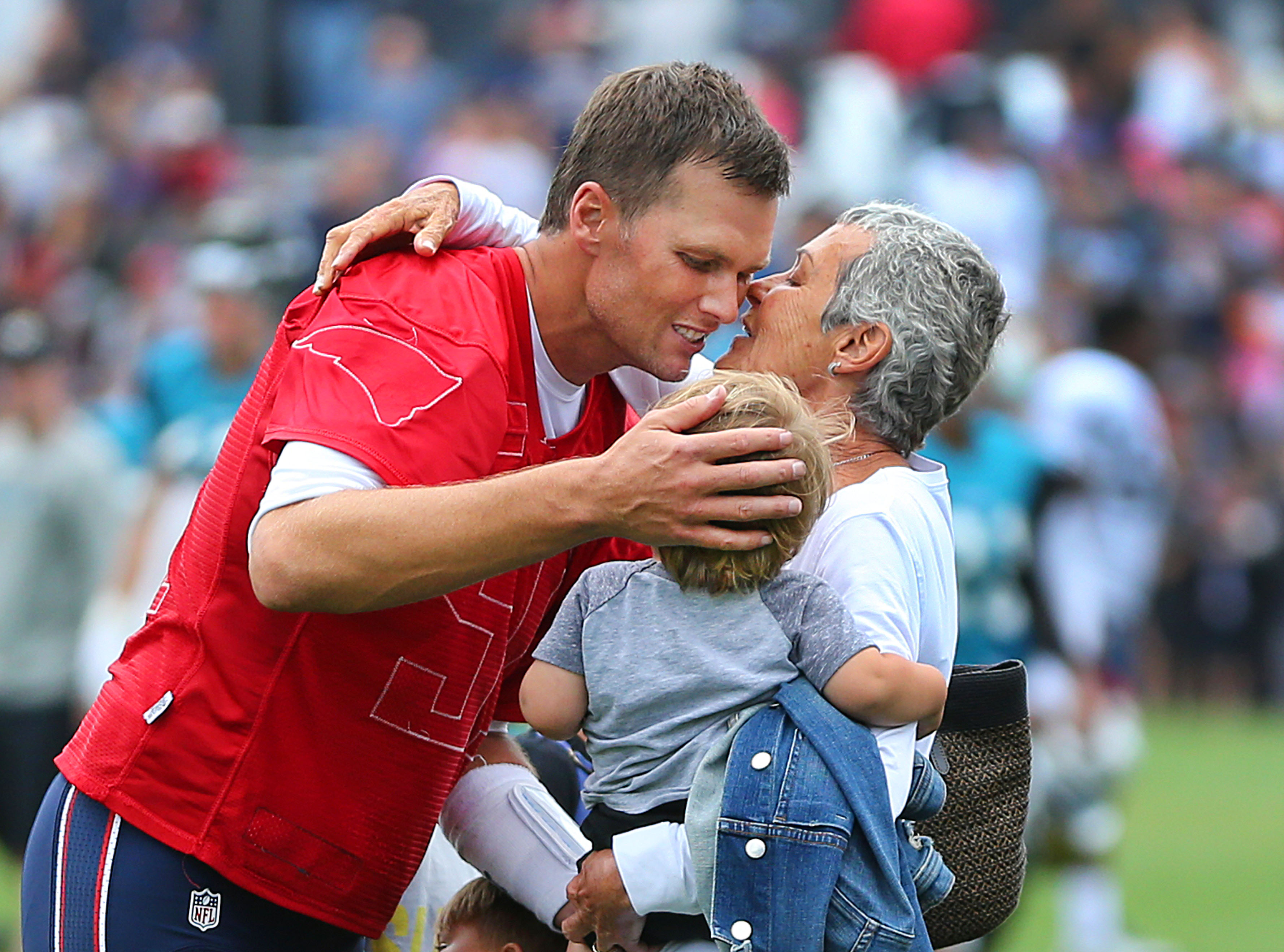 Tom Brady with his mother and nephew at the Gillette Stadium practice field in Foxborough, Massachusetts on August 8, 2017. | Source: Getty Images
