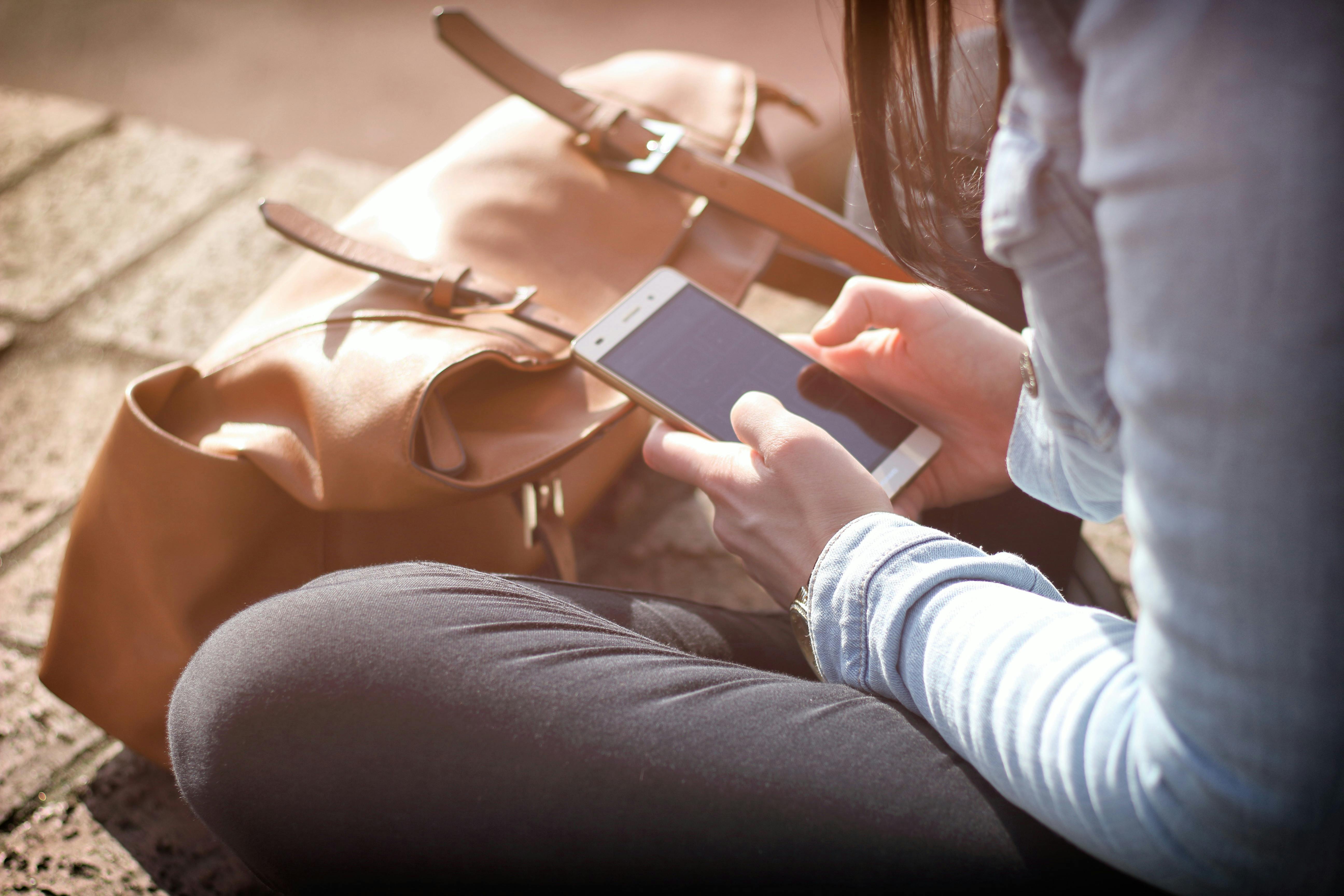 A woman using her phone | Source: Pexels