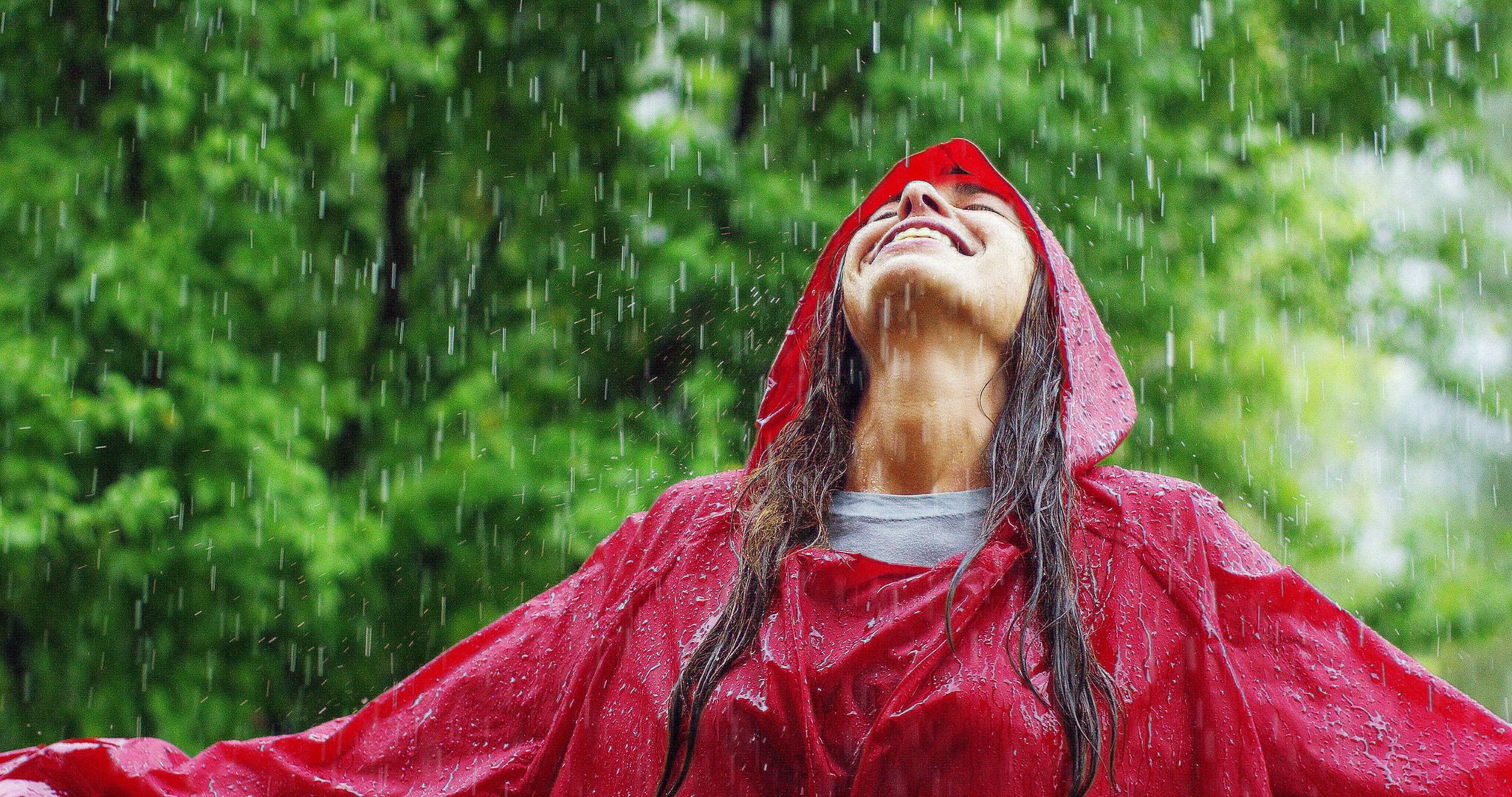 A woman enjoying the rain. | Source: Shutterstock