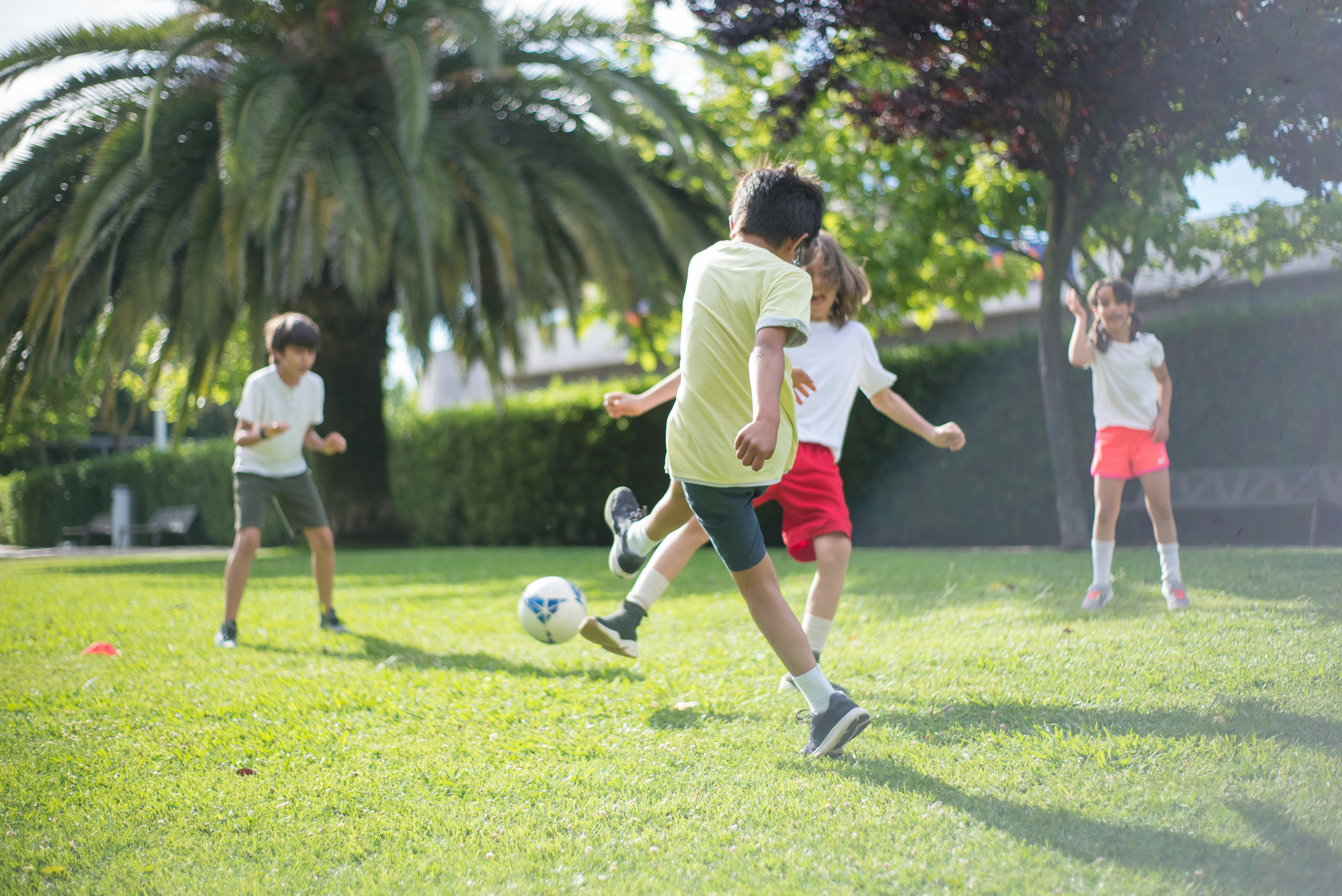 Kids playing football on the field | Source: Pexels