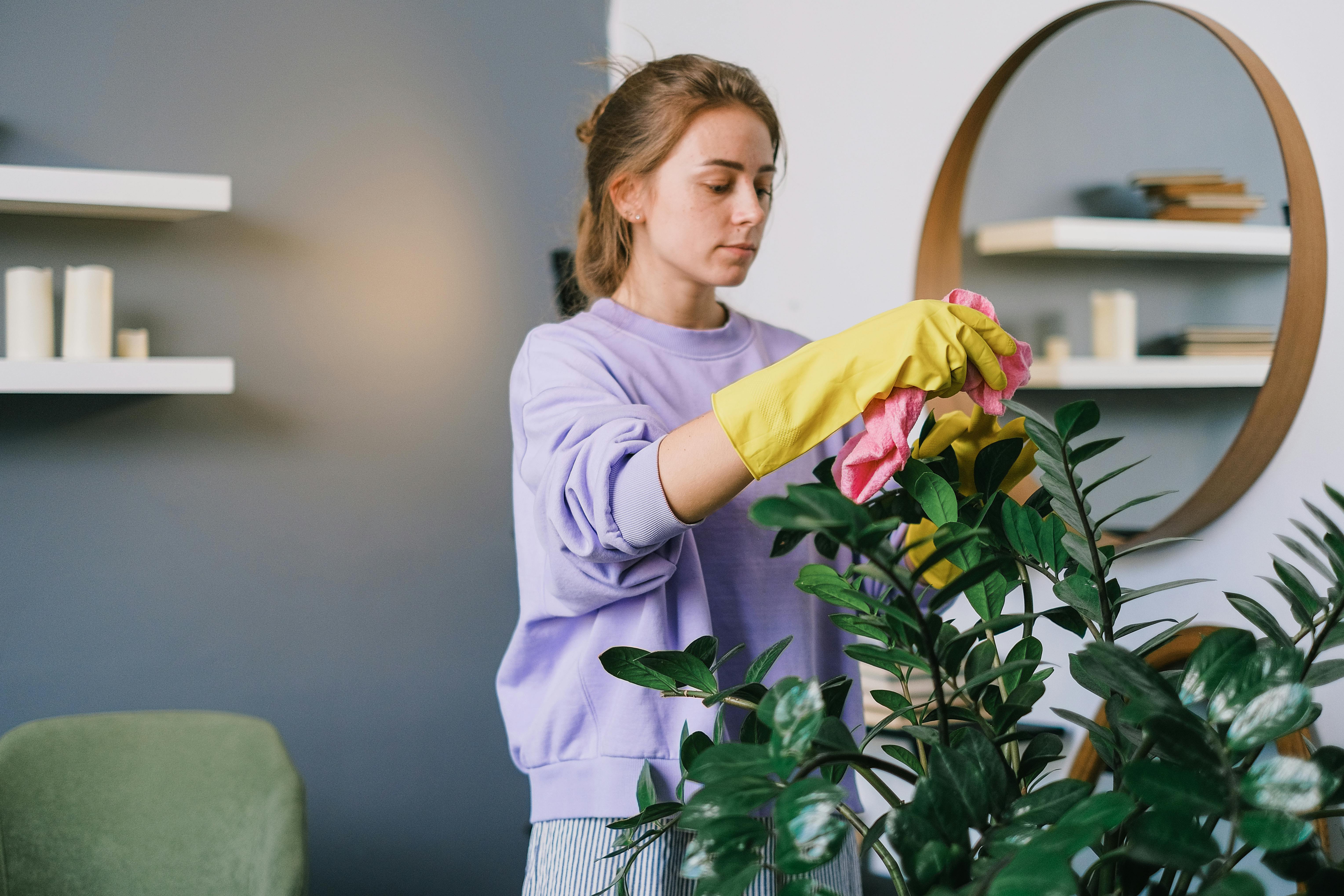 A woman caring for her plants | Source: Pexels
