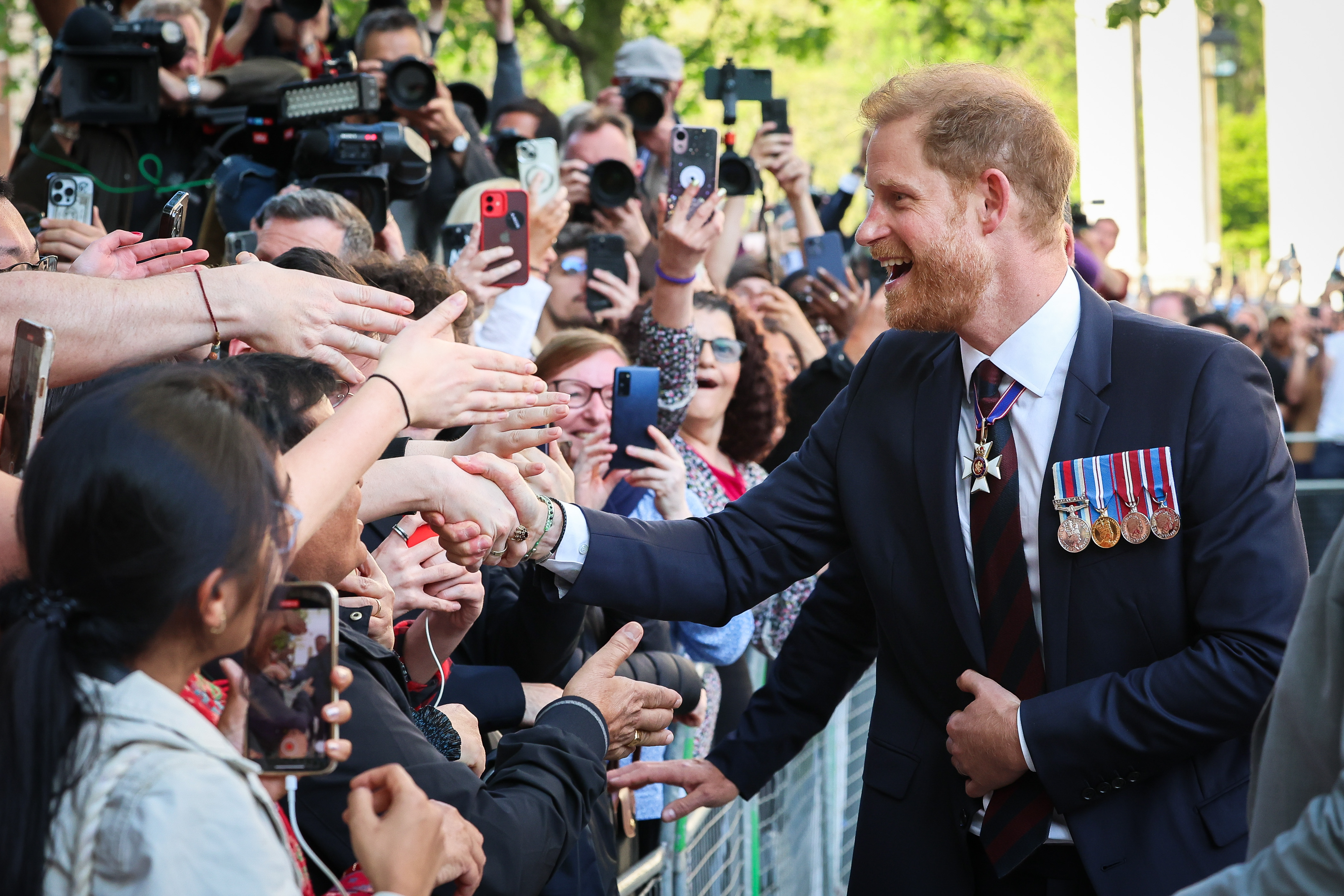 Prince Harry greets the public while departing The Invictus Games Foundation 10th Anniversary Service in London, England on May 8, 2024 | Source: Getty Images