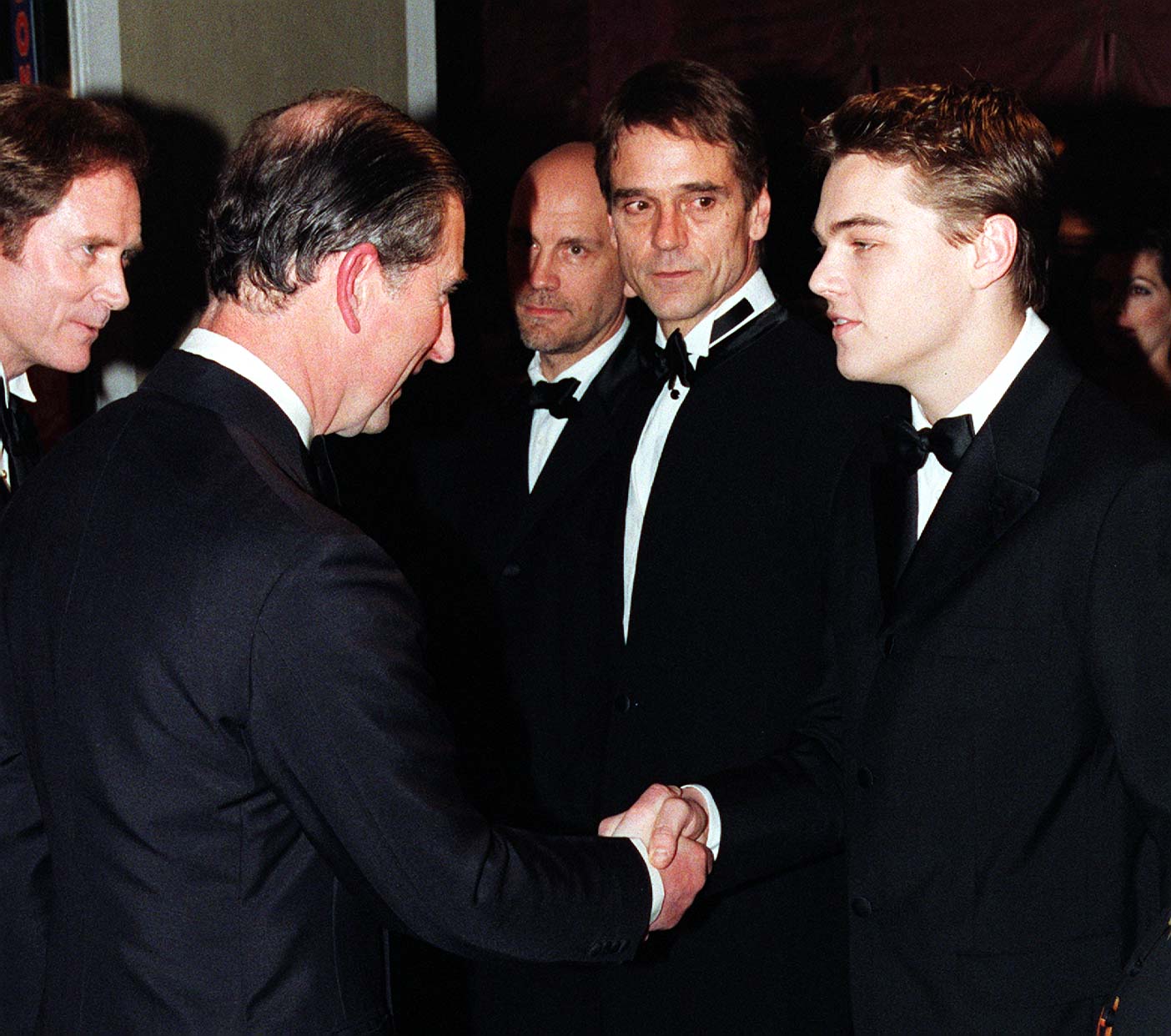 Charles Prince of Wales (now King Charles III) shakes hands with Leonardo DiCaprio at the Royal premiere of "The Man in the Iron Mask" on March 19, 1998 | Source: Getty Images