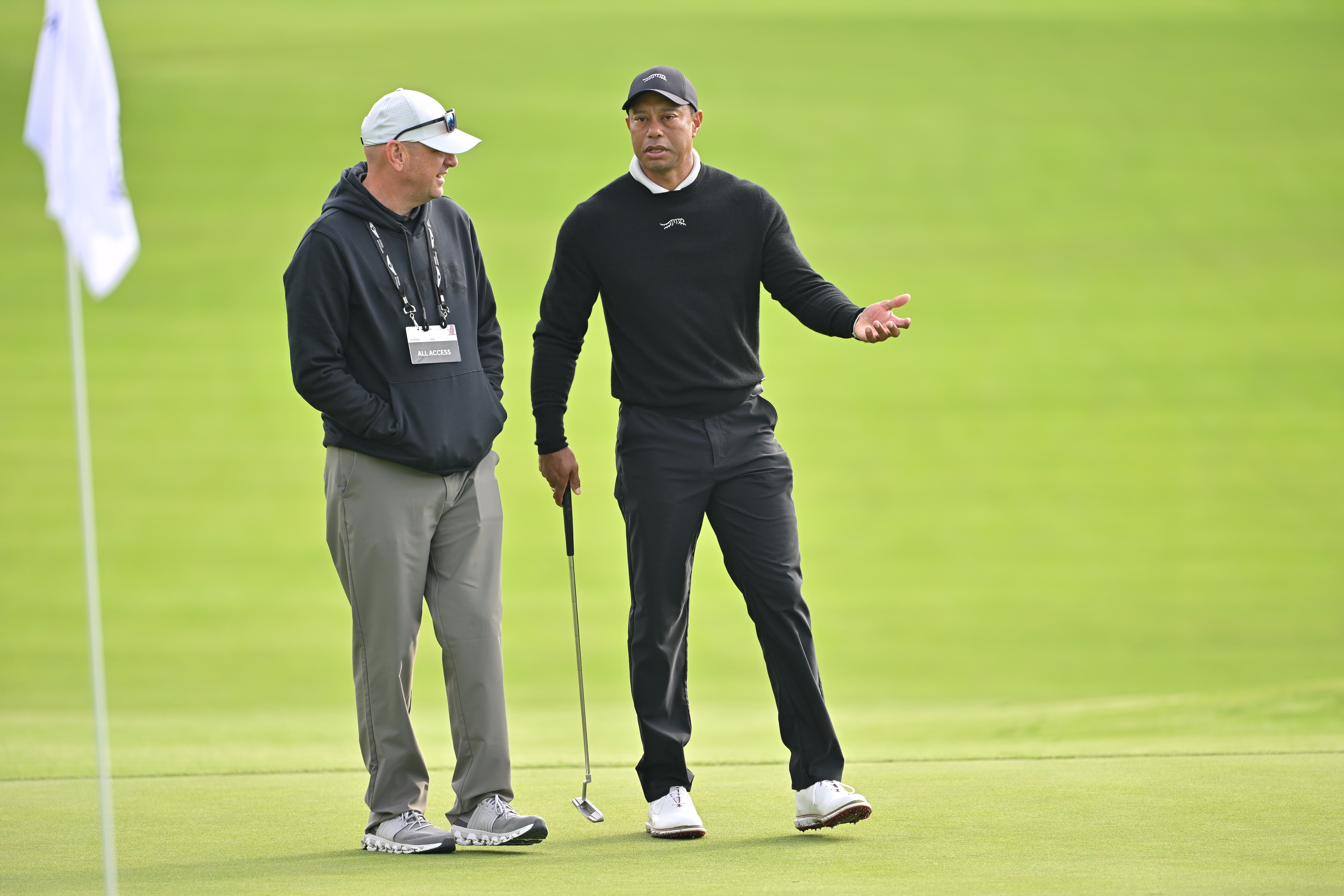 Rob McNamara and Tiger Woods having a conversation before The Genesis Invitational in Pacific Palisades, California on February 14, 2024 | Source: Getty Images