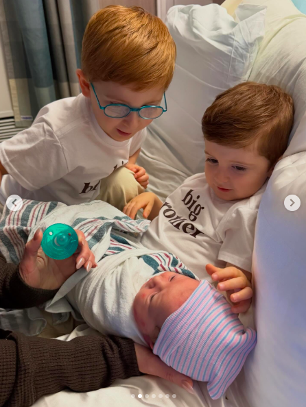 Meghan Trainor and Daryl Sabara's sons holding and looking at their baby sister, Mikey Moon Trainor, with love. | Source: Instagram/meghantrainor and darylsabara