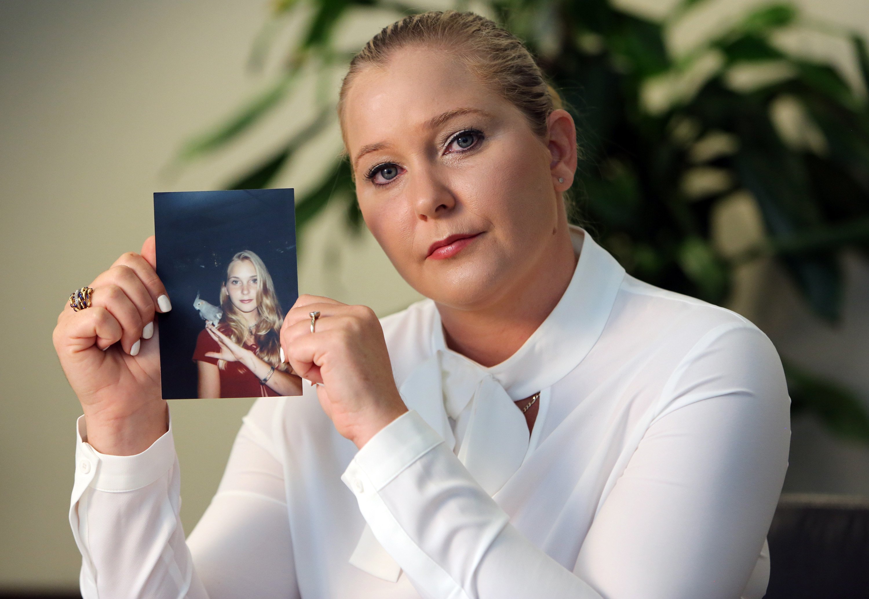 Virginia Roberts holds a photo of herself at age 16, when she says Palm Beach multimillionaire Jeffrey Epstein began abusing her sexually. | Source: Getty Images