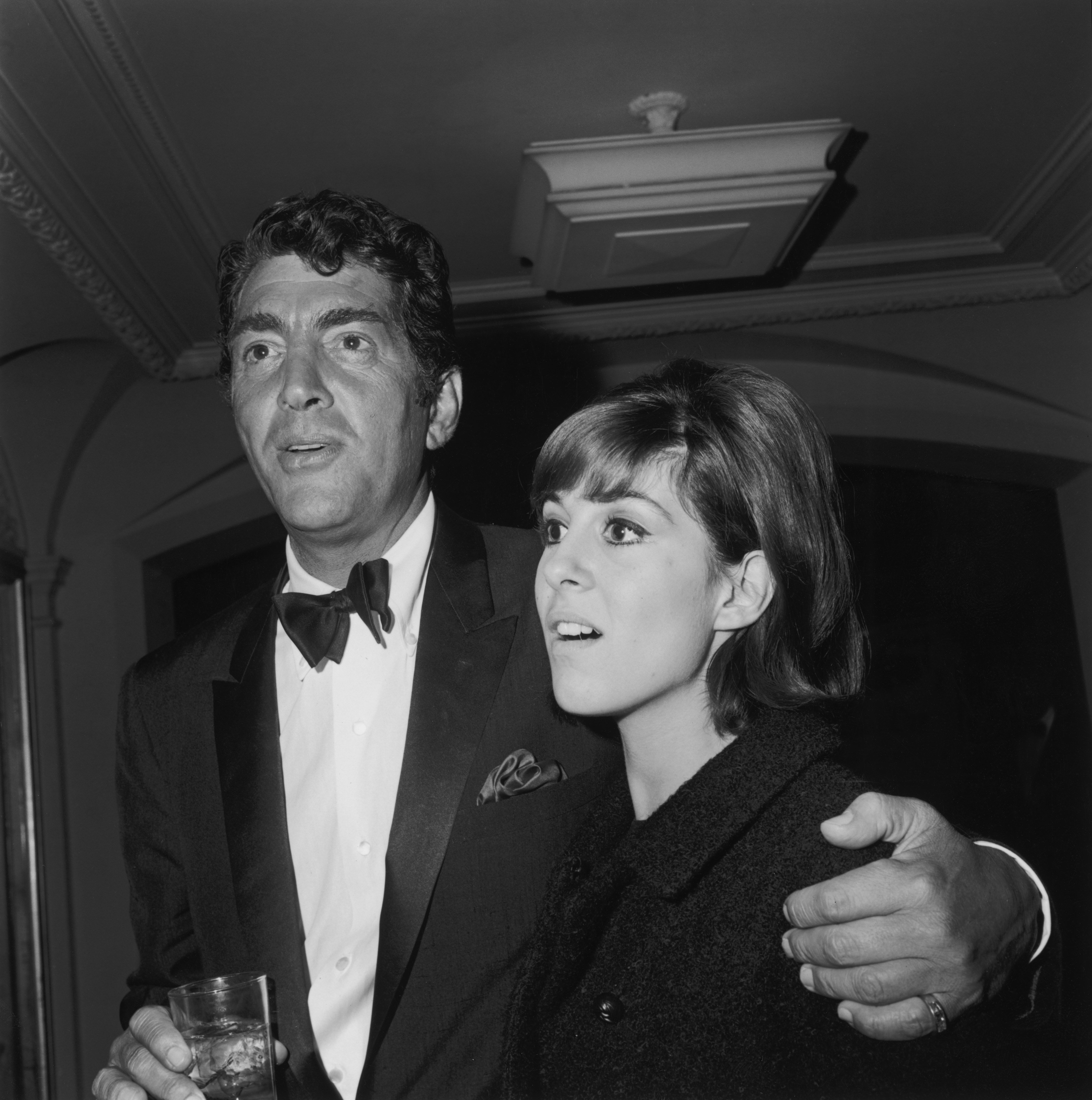American actor and singer Dean Martin with his arm around his daughter Deana at a Hollywood event, December 1965 | Photo: Getty Images