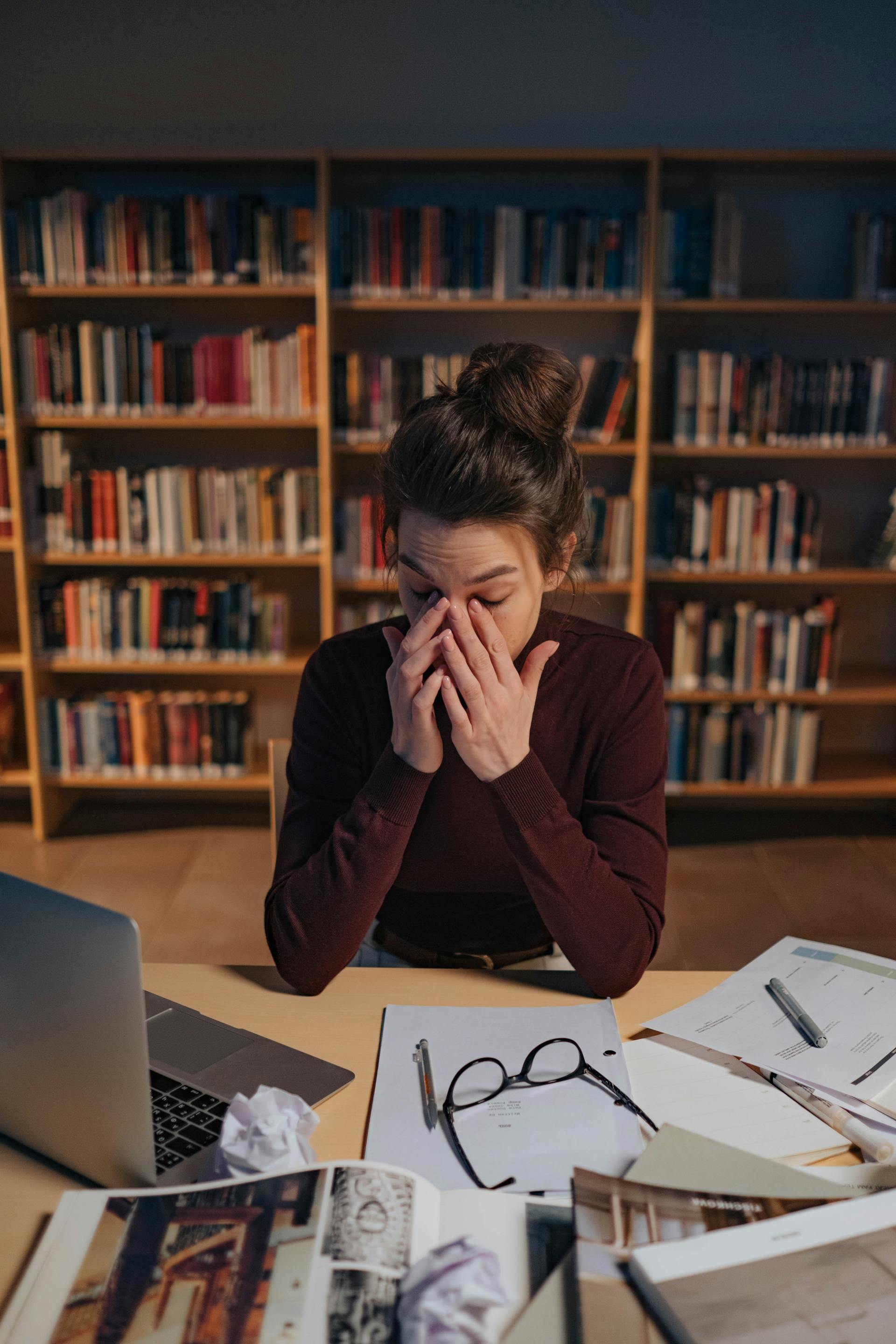 A woman studying in a library | Source: Pexels