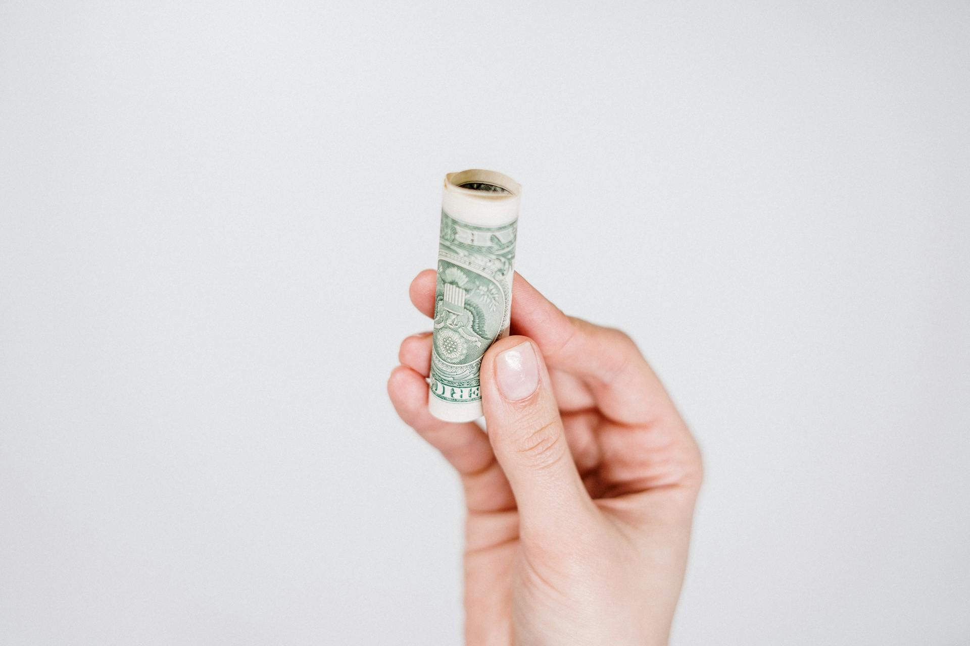 A woman holding money | Source: Pexels