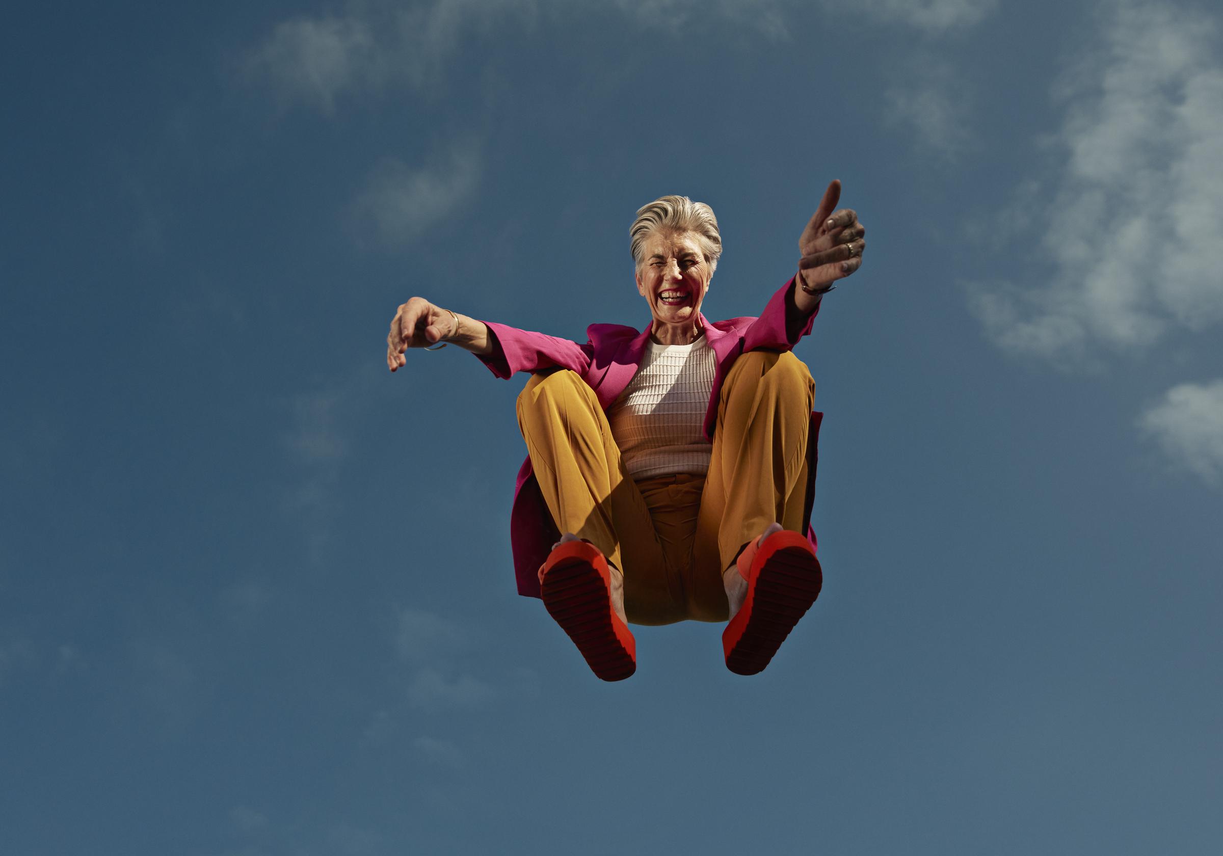 A woman crouching mid-air against the blue sky | Source: Getty Images