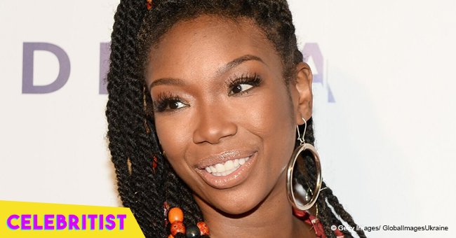 Brandy melts hearts with photo of daughter in braids, T-shirt & tight black shorts