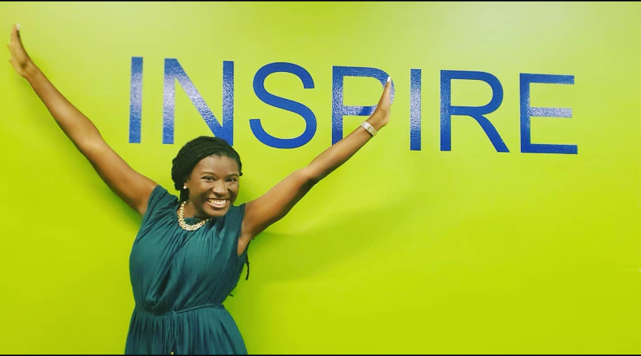 Beaming with energy, Nancy Metayer Bowen stretches her arms wide beneath the bold word “INSPIRE,” embodying the message with joy, confidence, and purpose. | Source: Instagram/nancymetayerbowen