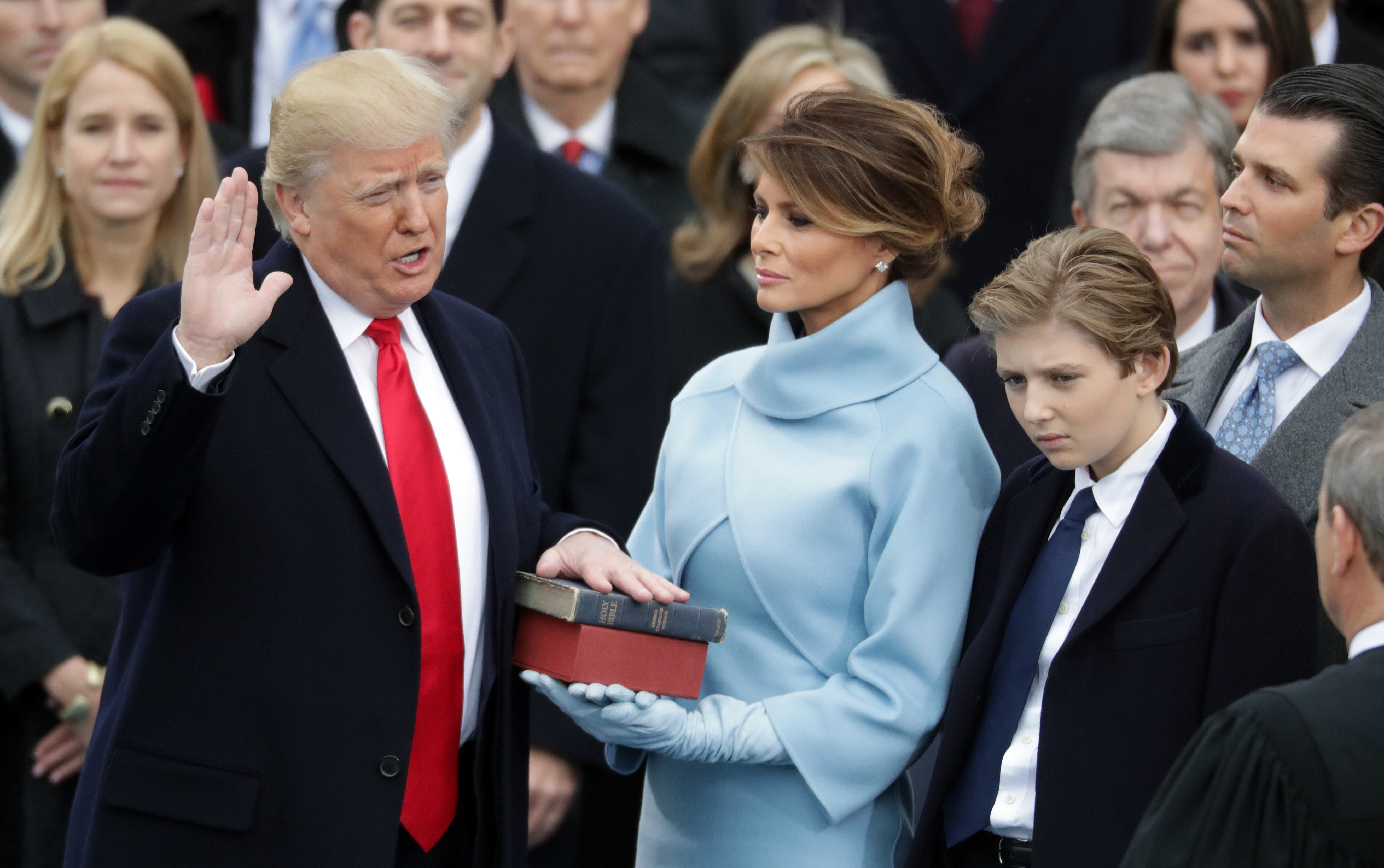 Donald Trump takes the oath of office as Melania Trump holds the bible and Barron Trump looks on, in Washington, DC | Source: Getty Images