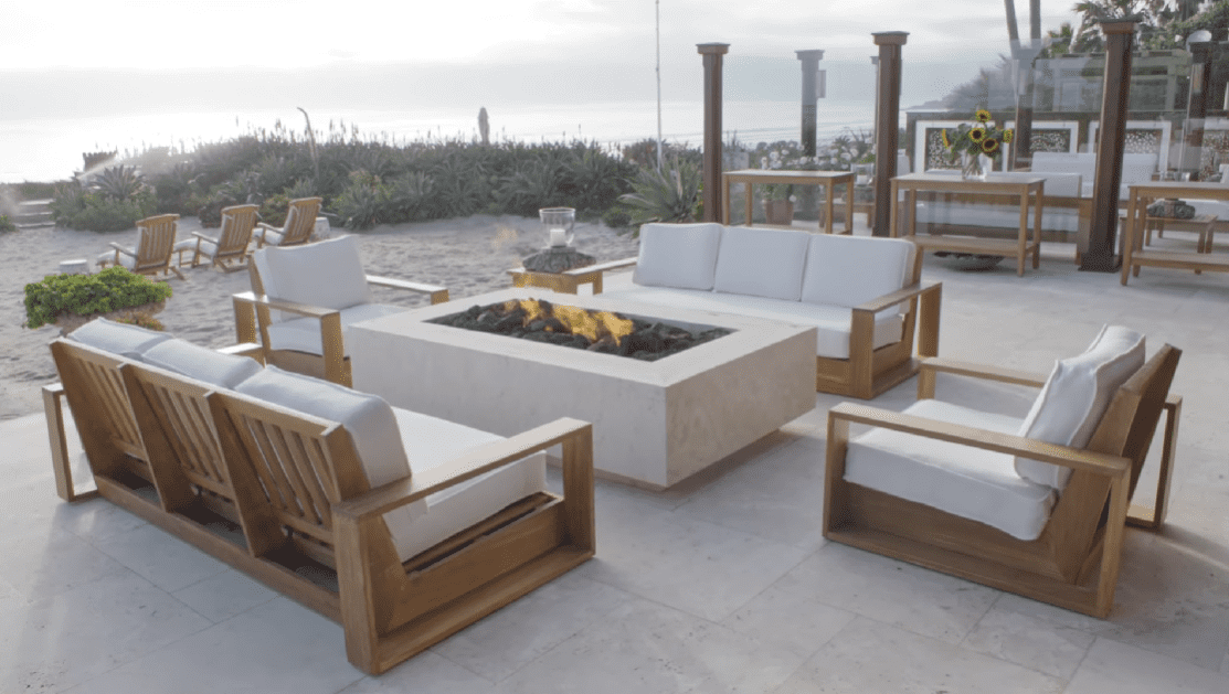 Pierce Brosnan and Keely Smith's outdoor lounge area with a centered fire pit. / Source: YouTube/@ArchitecturalDigestIndia
