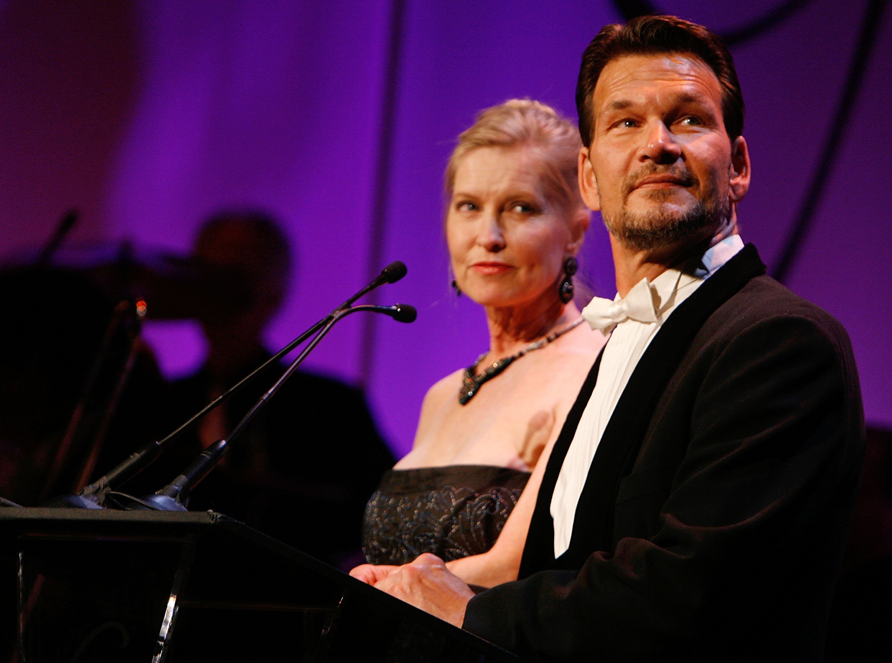 Lisa Niemi (L) and actor Patrick Swayze speak onstage during the 9th annual Costume Designers Guild Awards held at the Beverly Wilshire Hotel on February 17, 2007 in Beverly Hills, California. | Source: Getty Images